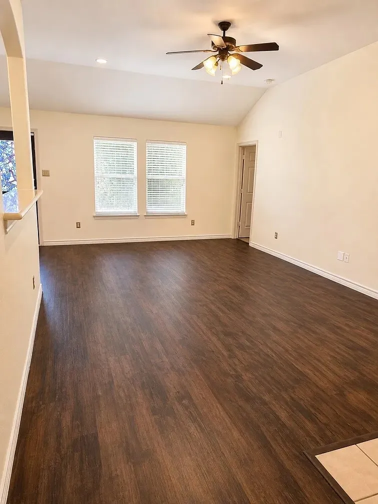 Vaulted ceilings, wood-finish flooring, dual windows, and a ceiling fan with integrated lighting
