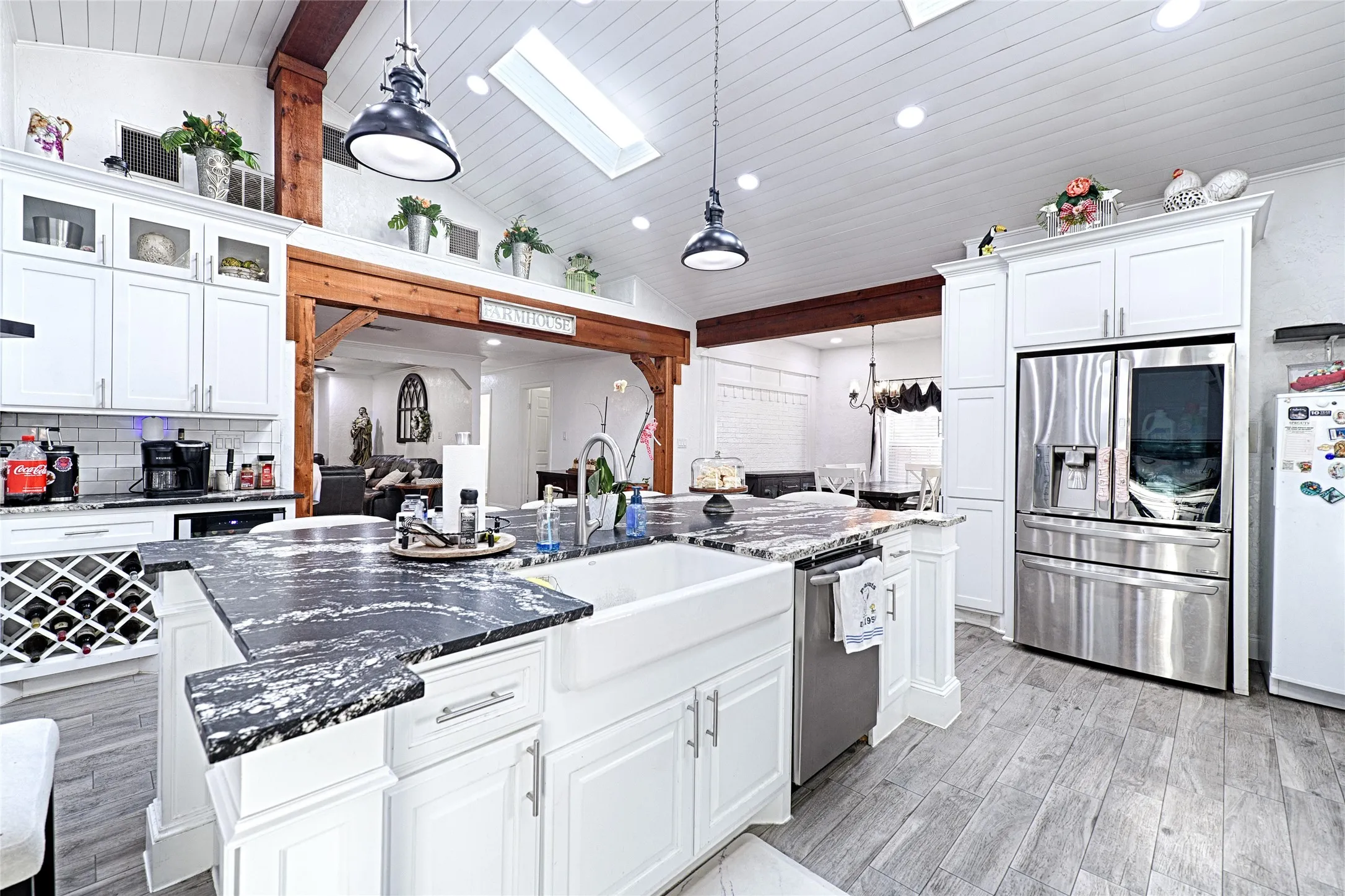 Stainless steel appliances, decorative range hood, and pendant lighting.