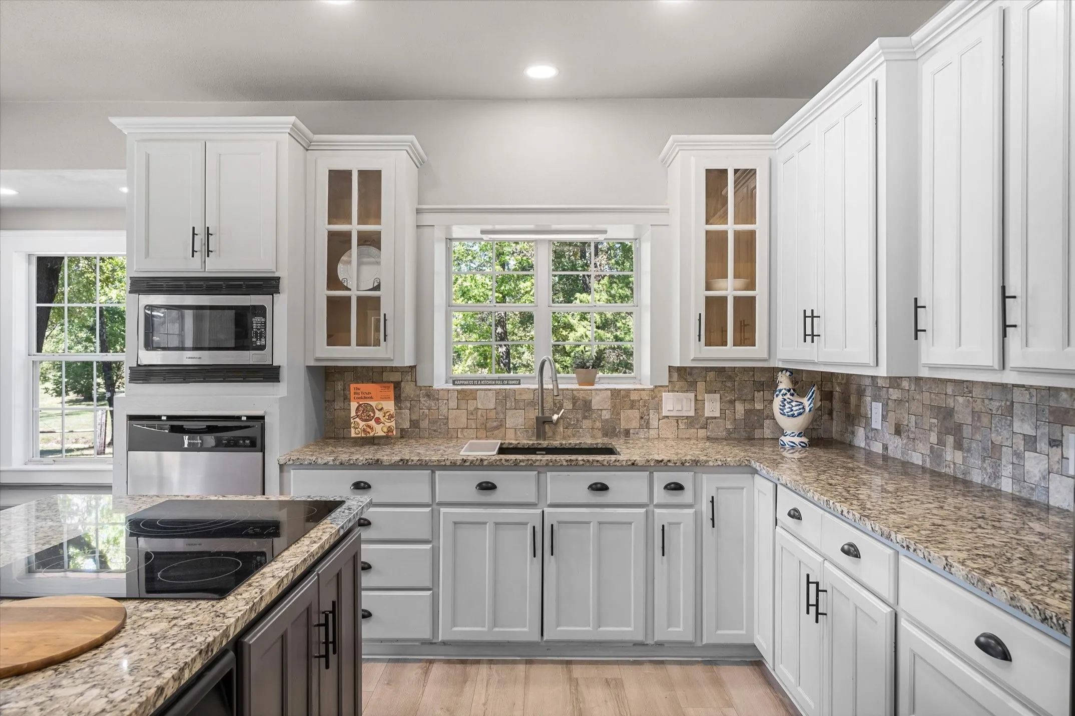 Granite counters glass front cabinets, tiled backsplash, composite farm sink. Great space for the family chef.
