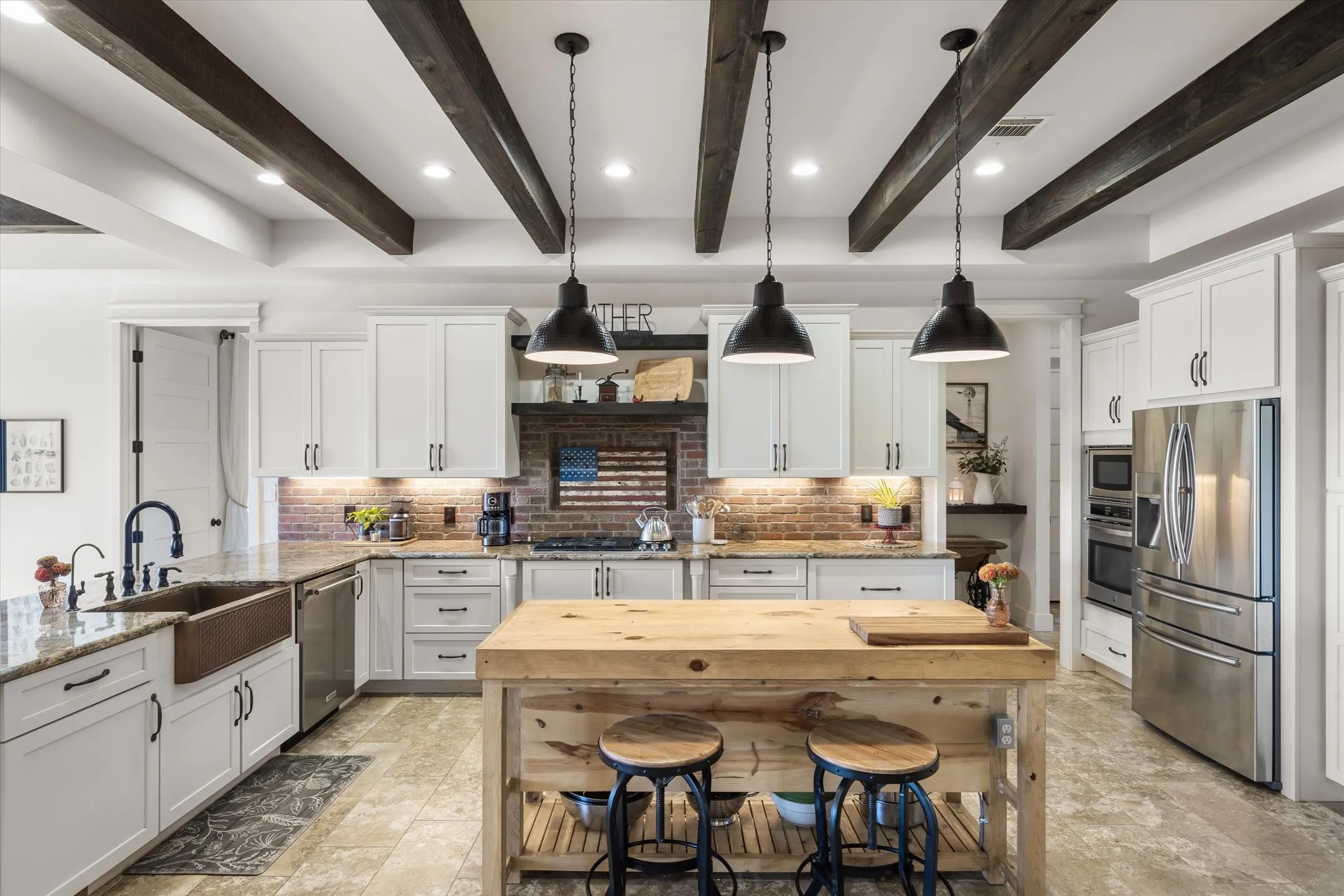 Copper apron farm sink, double ovens and cabinets galore make this a gourmet kitchen