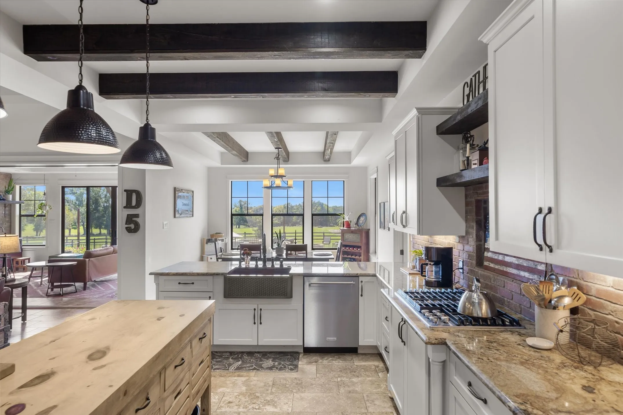 Gas commercial size stove. Granite counters and a butcher block island