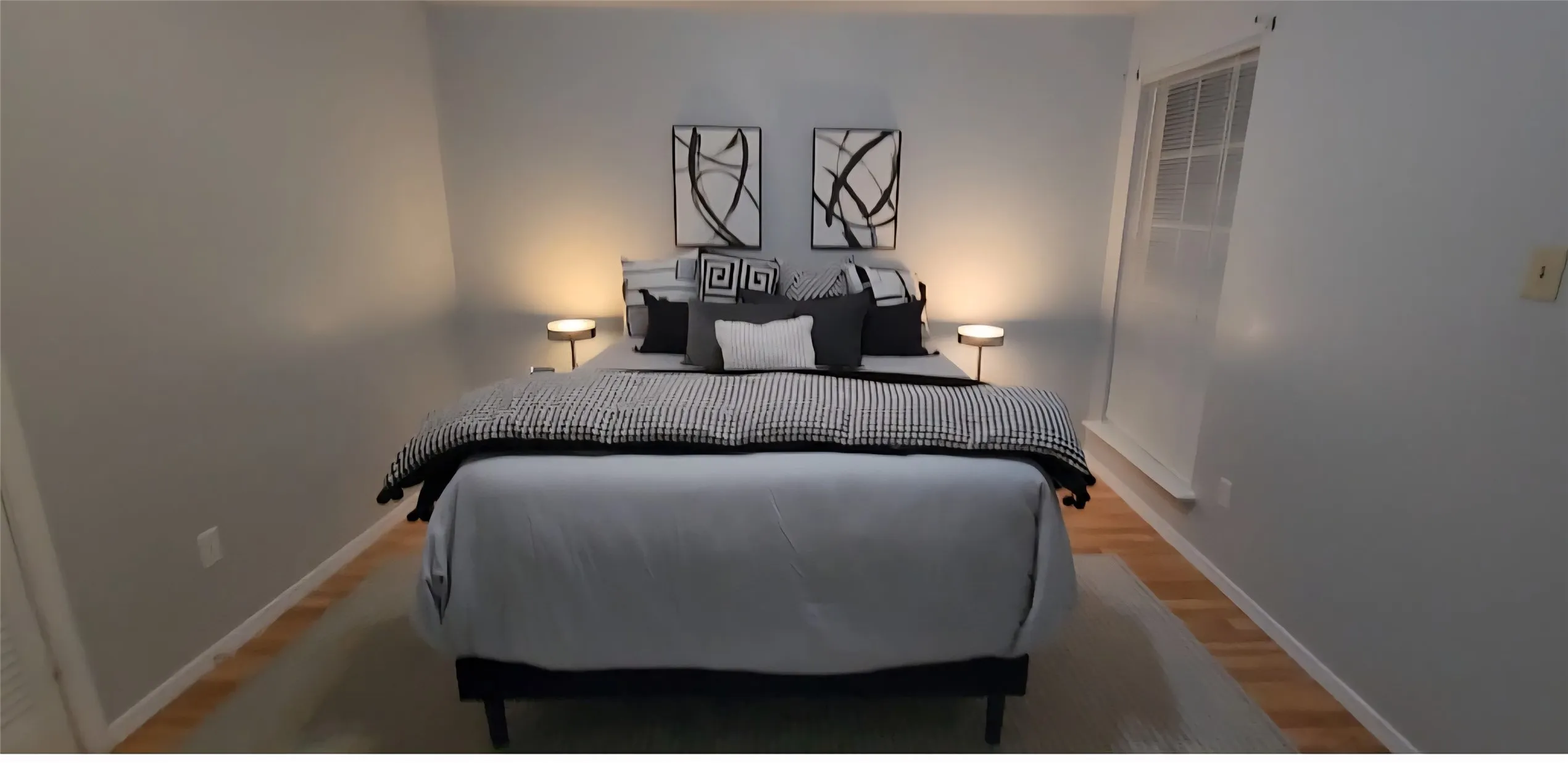 Neutral wall tones, wood-finish flooring, and a multi-pane window with deep sill