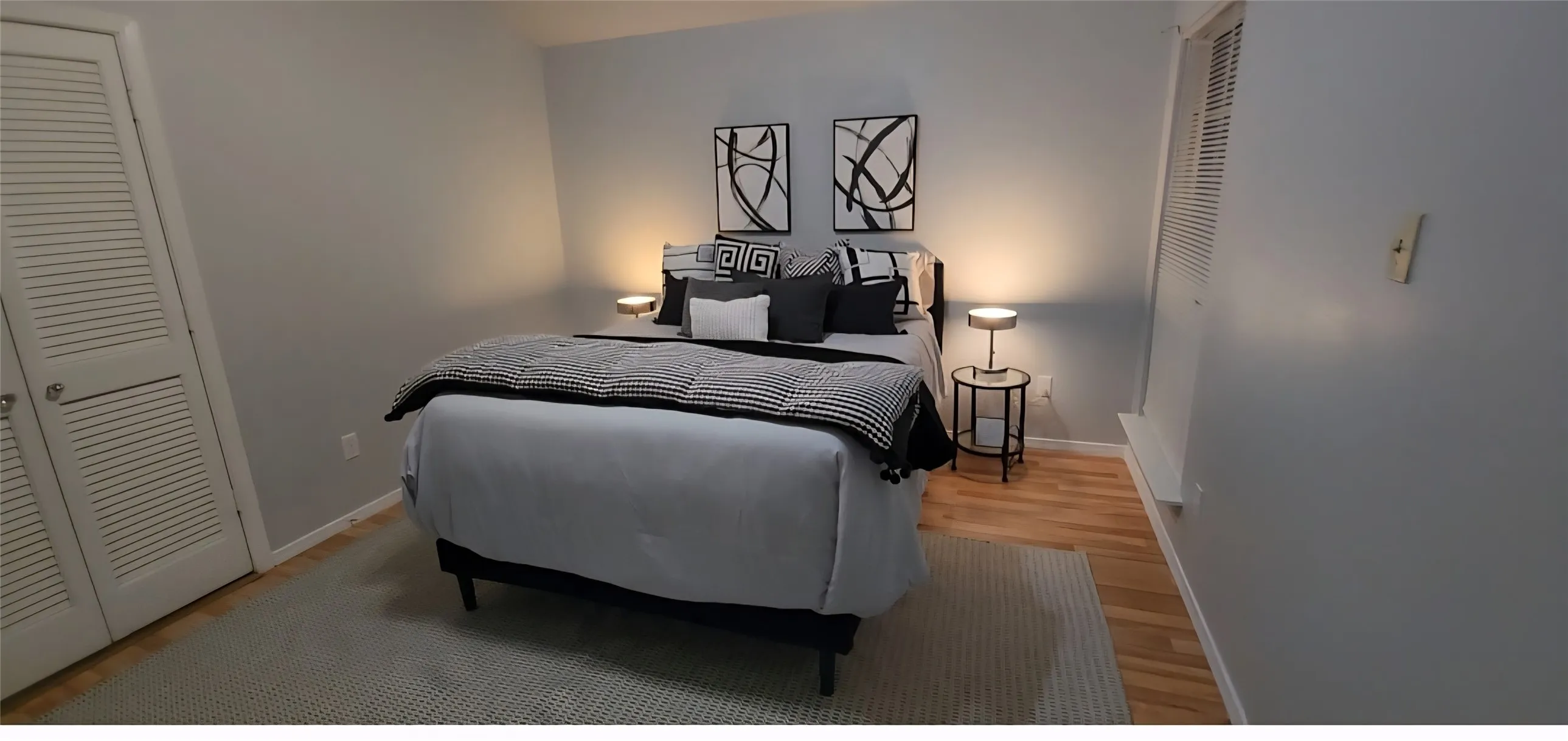 Room featuring wood-finish flooring, dual bi-fold closet doors, and recessed lighting