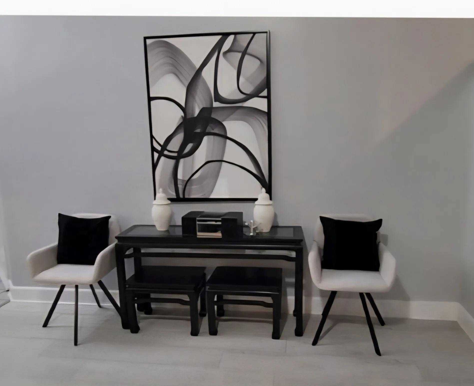 Neutral-toned interior space featuring light wood-finish flooring and grey wall surfaces