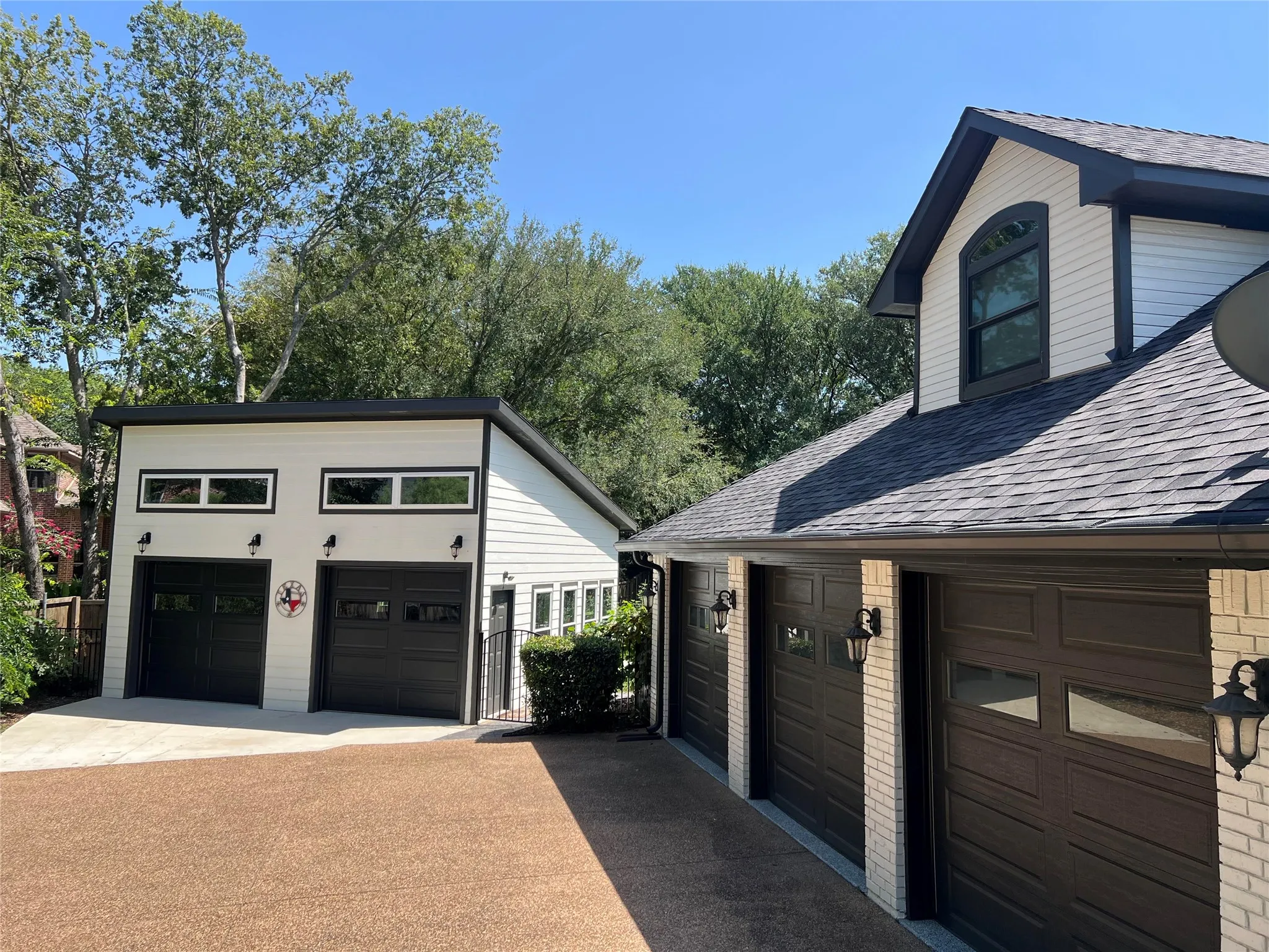 The recently constructed oversized 2 car garage has a high ceiling to accommodate a lift.