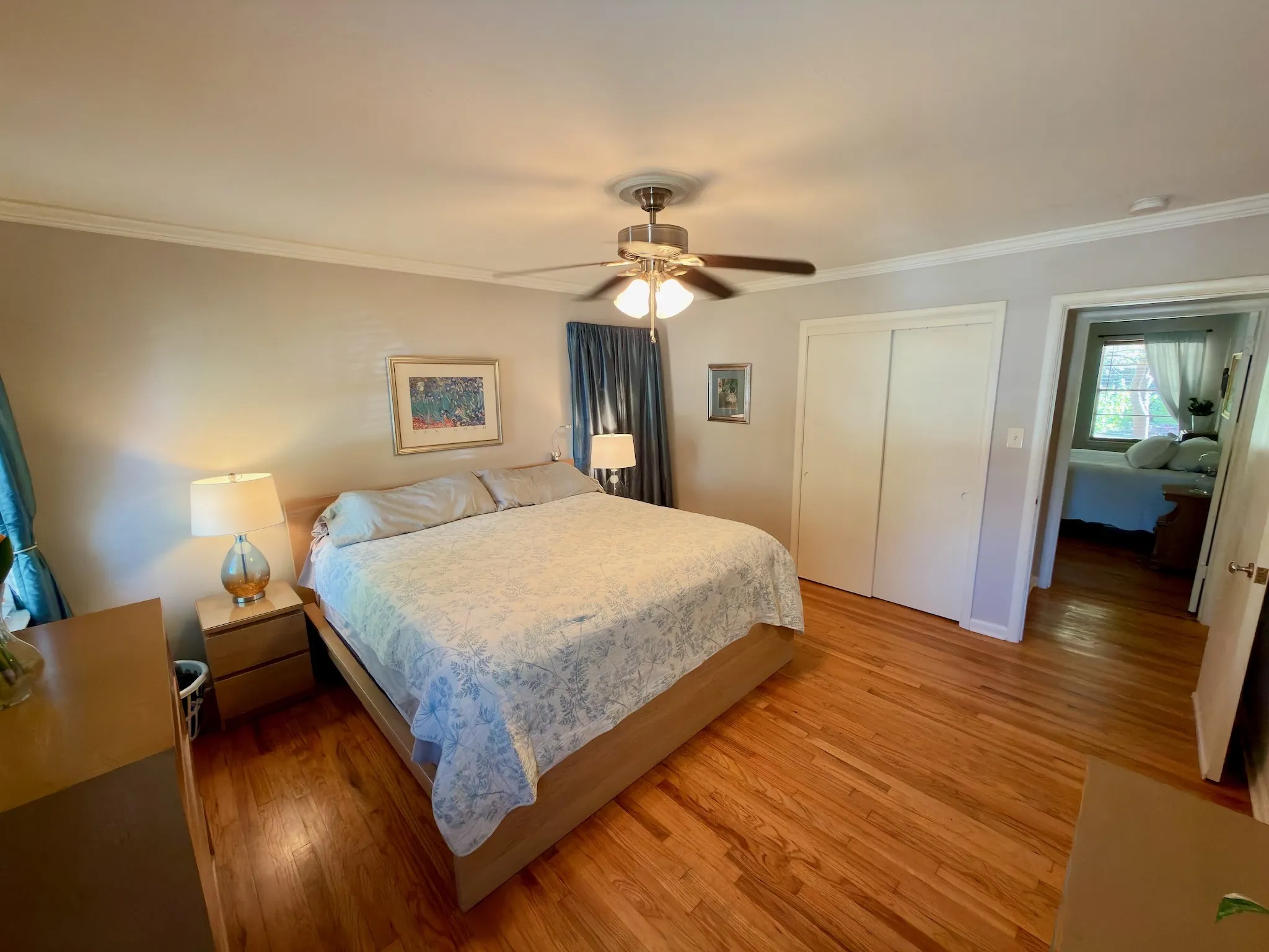 13x13 Hardwood flooring, crown molding, ceiling fan with integrated lighting, and dual-panel closet doors