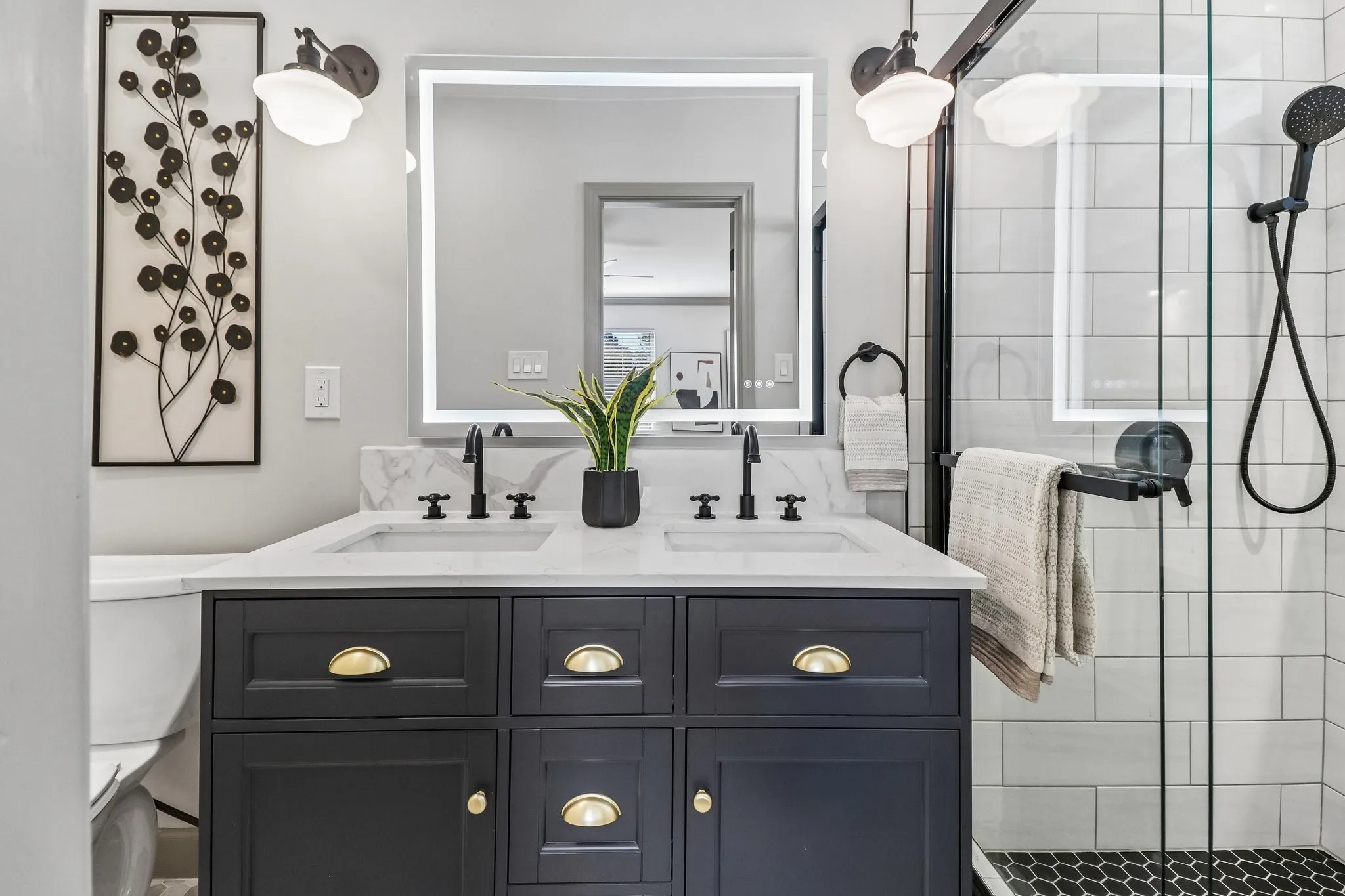 Double vanity with a white countertop and undermount sinks