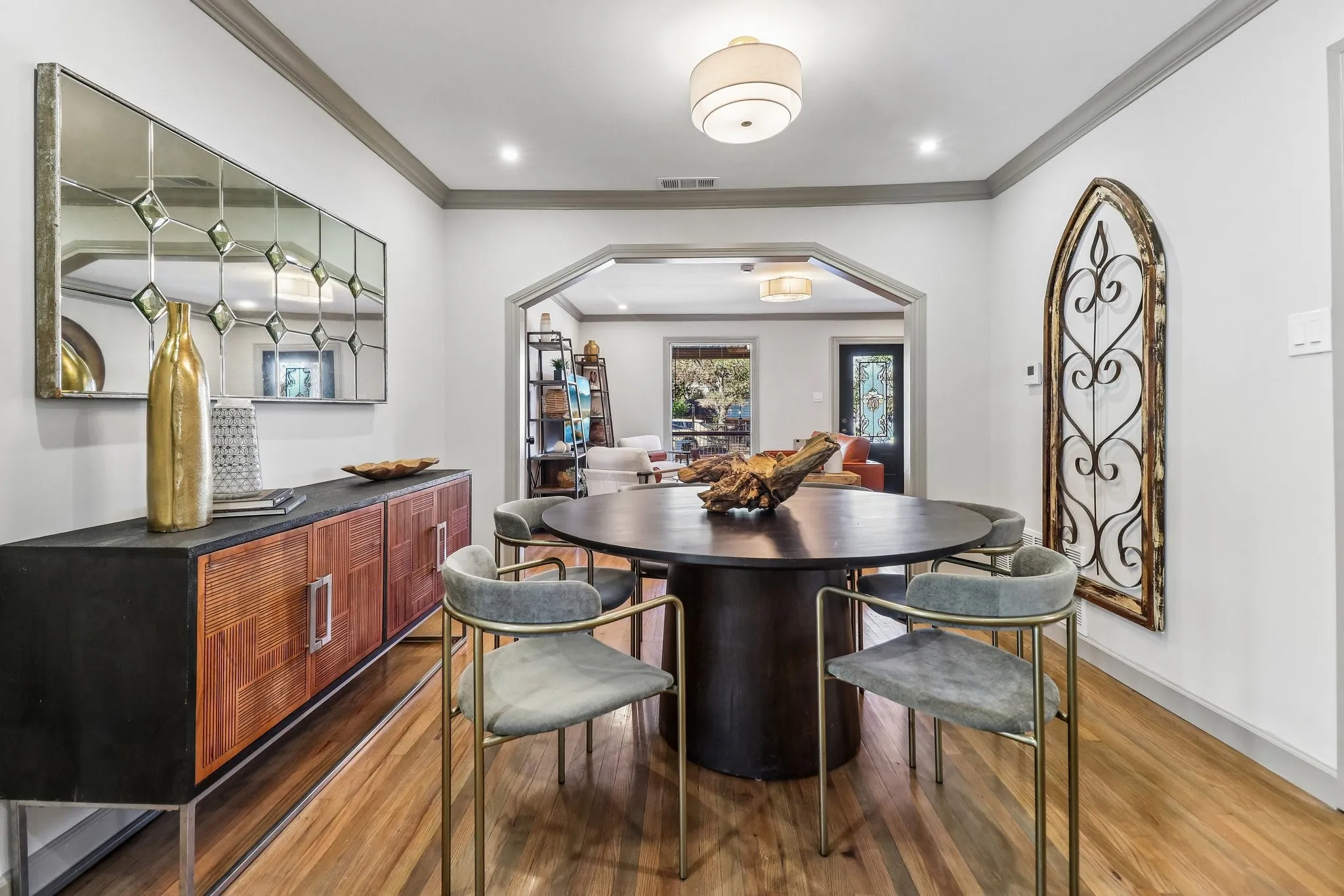 Hardwood flooring, crown molding, arched entryway, recessed lighting, and a drum-style ceiling fixture