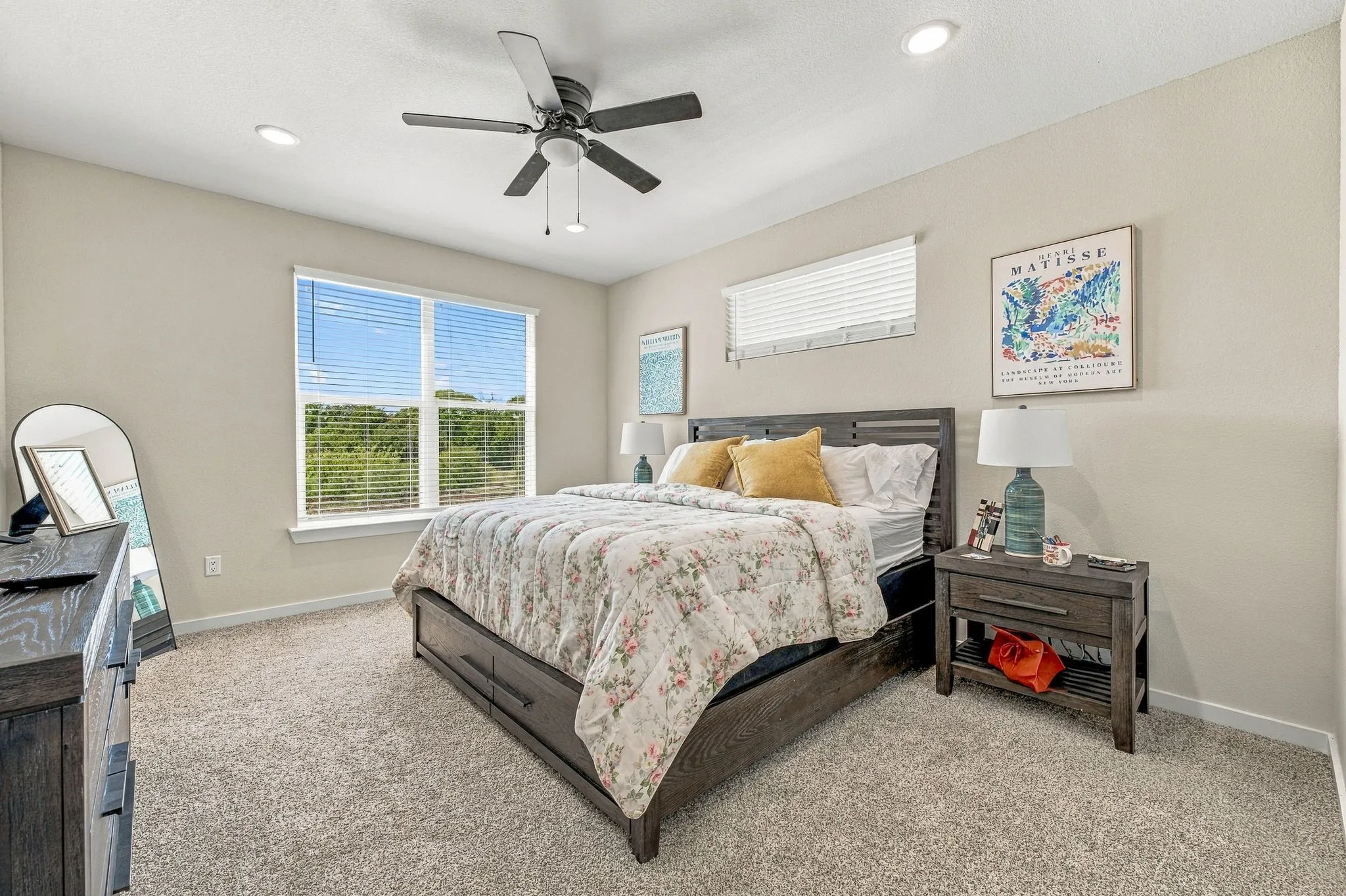Spacious room featuring neutral wall tones, recessed lighting, carpeted flooring, a ceiling fan, and large windows with horizontal blinds