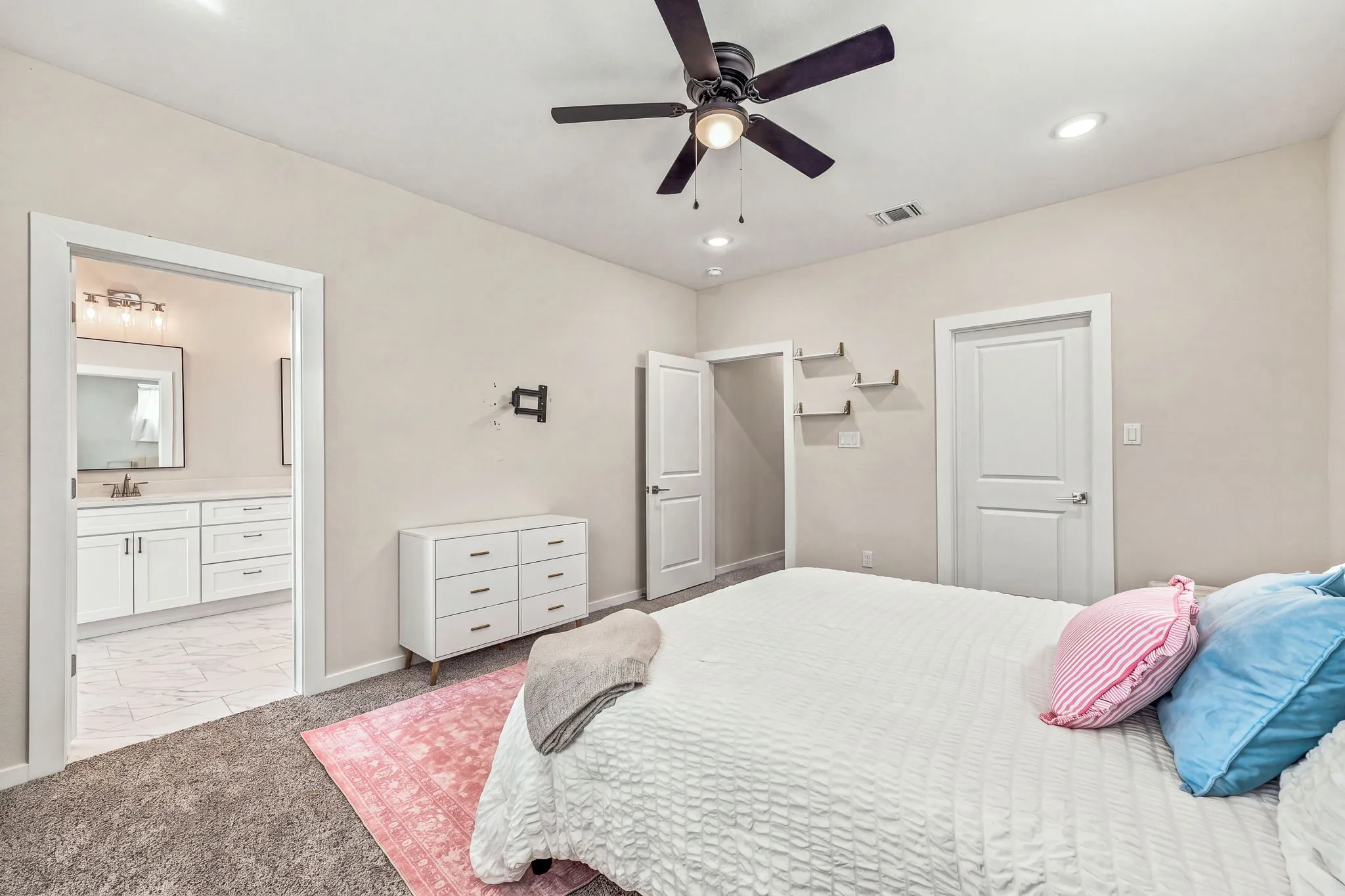 Interior room featuring neutral wall tones, recessed lighting, a ceiling fan, plush carpeting, and two interior doors with panel detailing