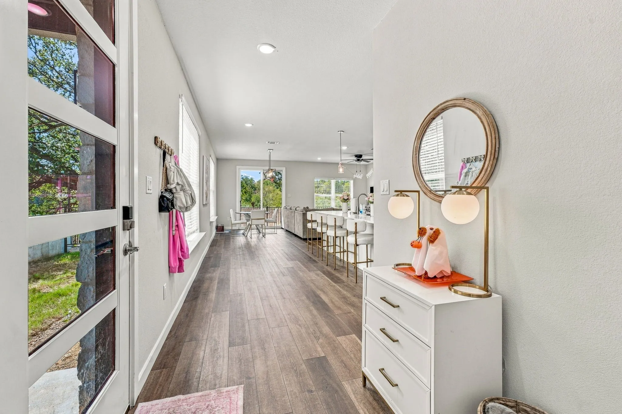 Entryway featuring a multi-pane glass door, wood-finish flooring, recessed lighting, and a neutral color palette