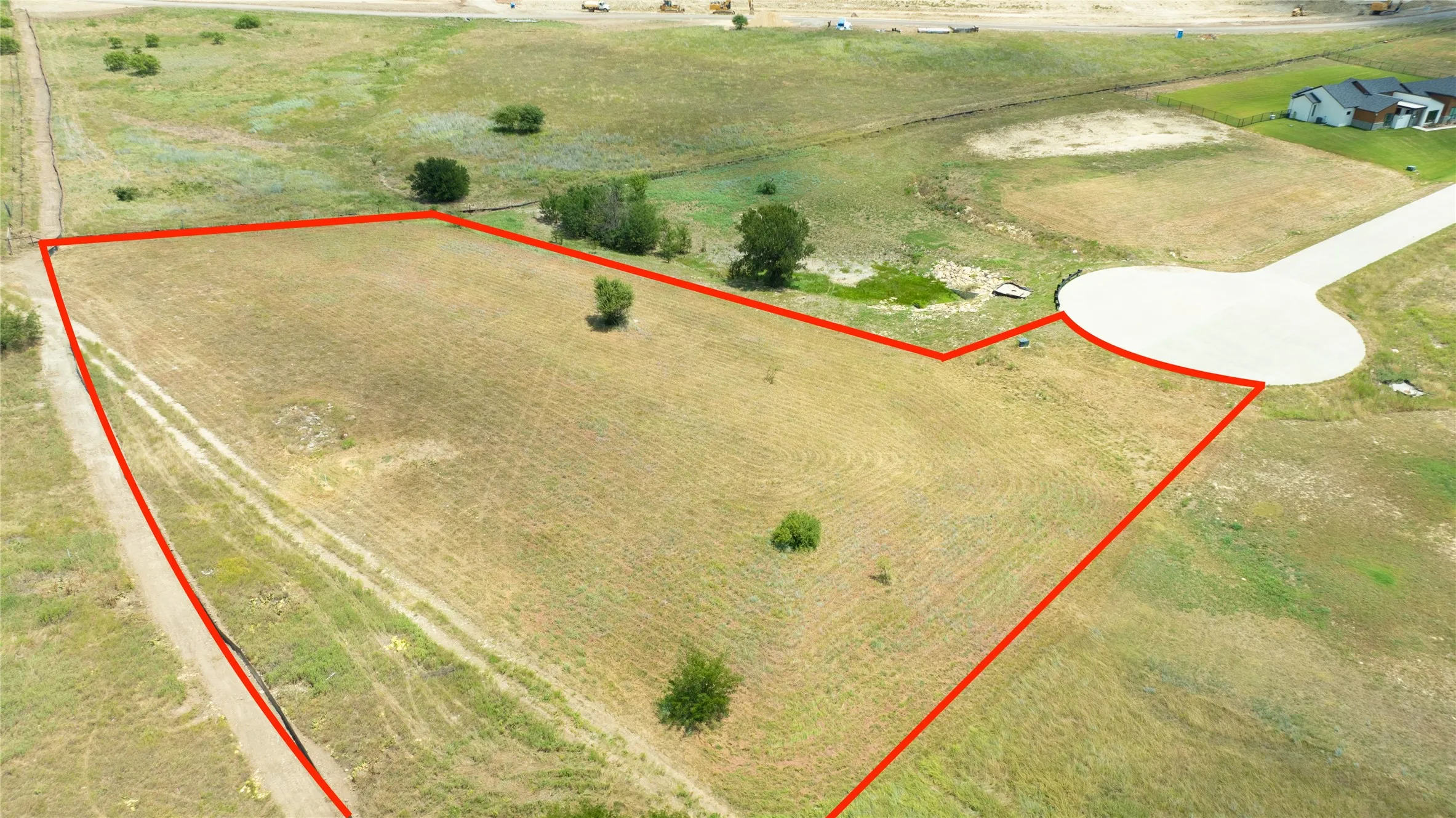Vacant residential lot featuring direct access to a concrete cul-de-sac and mature trees