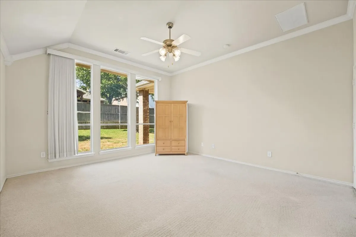 Primary Bedroom with Large windows overlooking the backyard