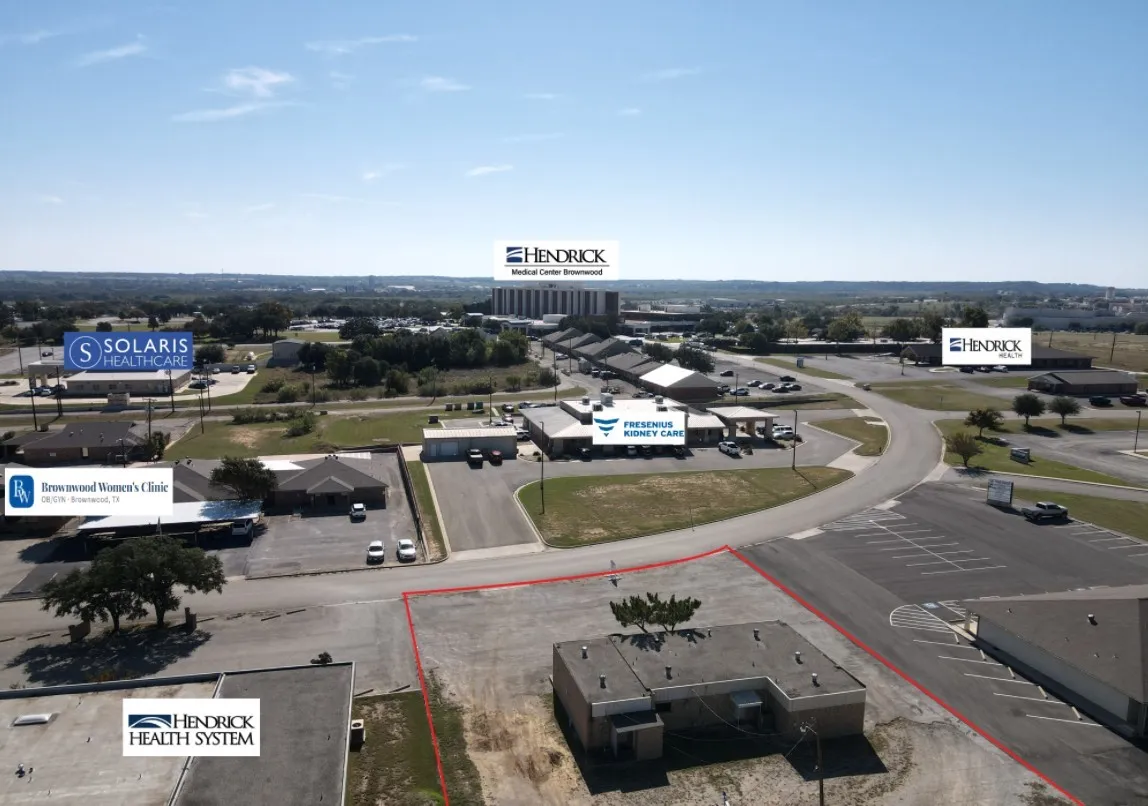 Commercial lot featuring paved street access, concrete foundation, and proximity to regional medical facilities