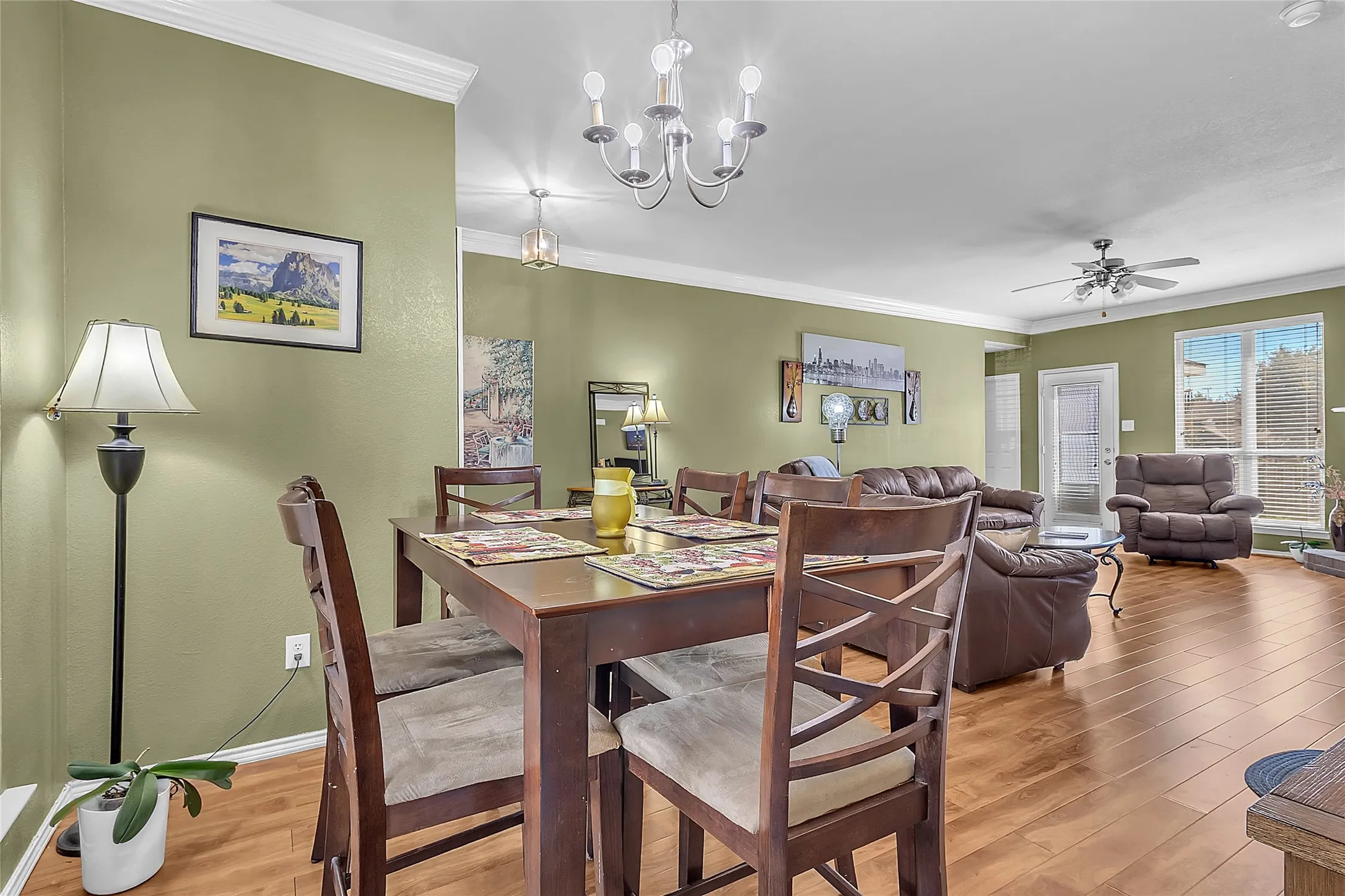 Dining opens to living room with fireplace and backyard glass door