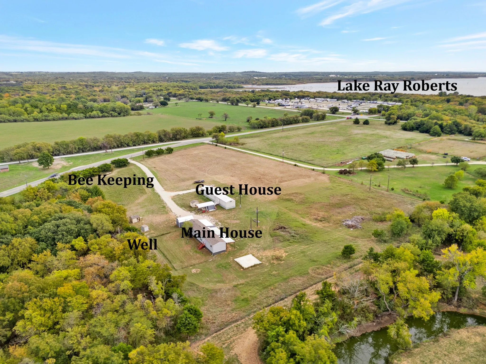Expansive acreage featuring a main house, guest house, onsite well, and dedicated apiculture area