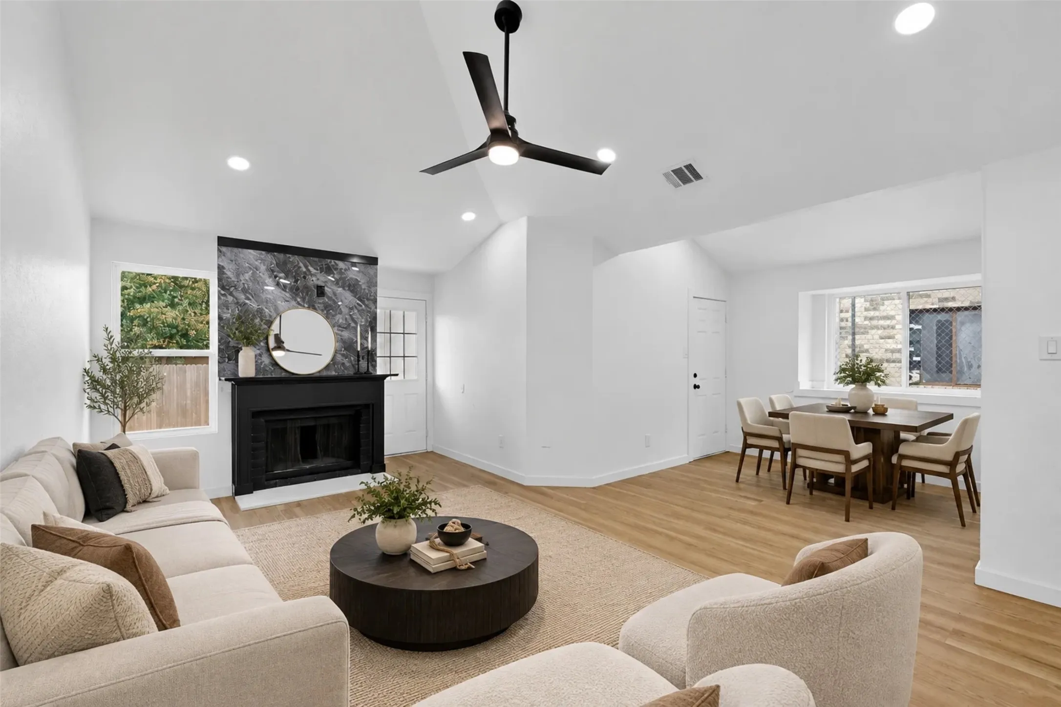 Vaulted ceilings, wood-finish flooring, and recessed lighting throughout