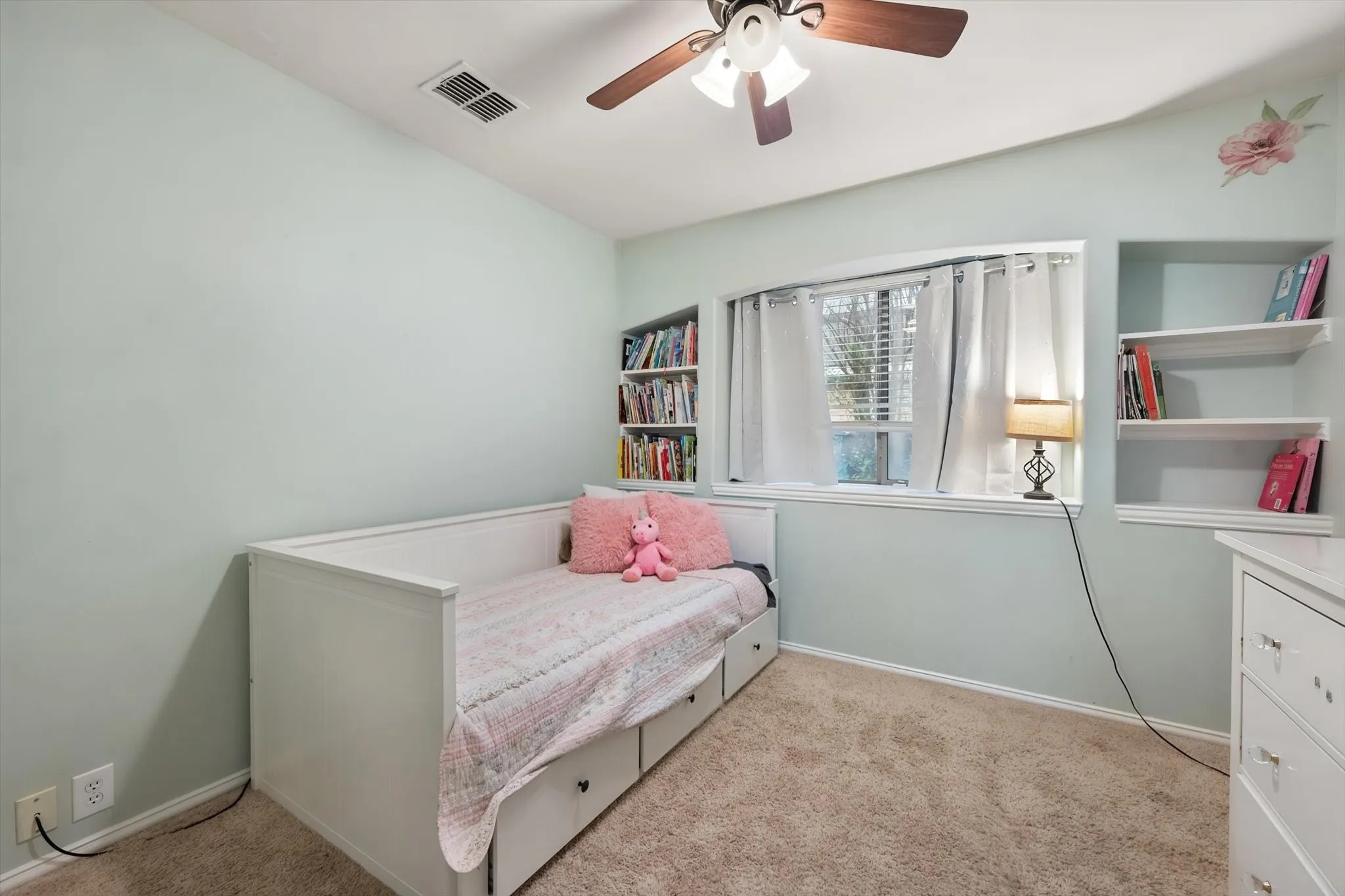 Bedroom 3 has plush carpet and ceiling fan.