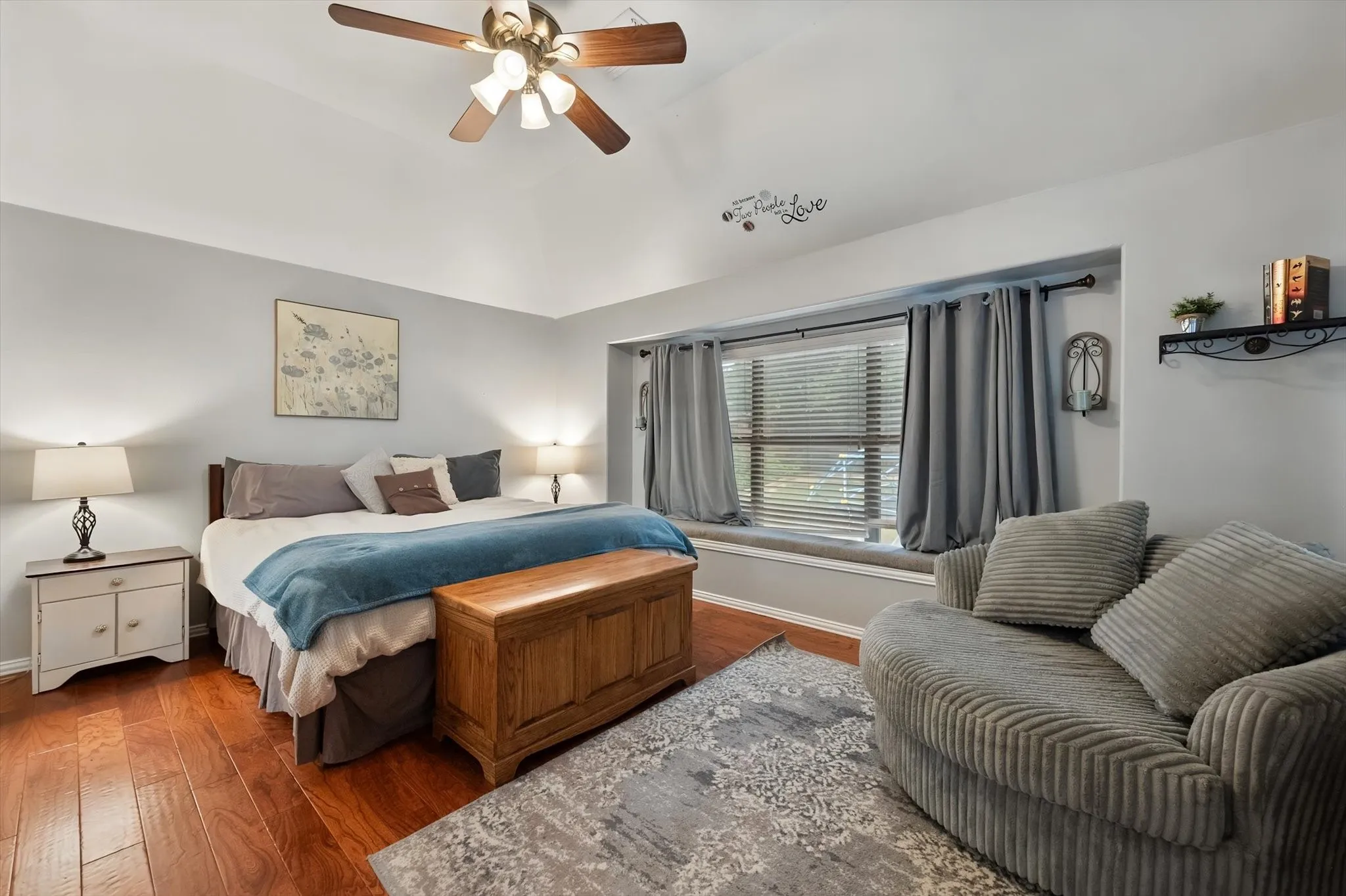 Spacious primary bedroom boasts luxury vinyl plank, vaulted ceilings and window seat.