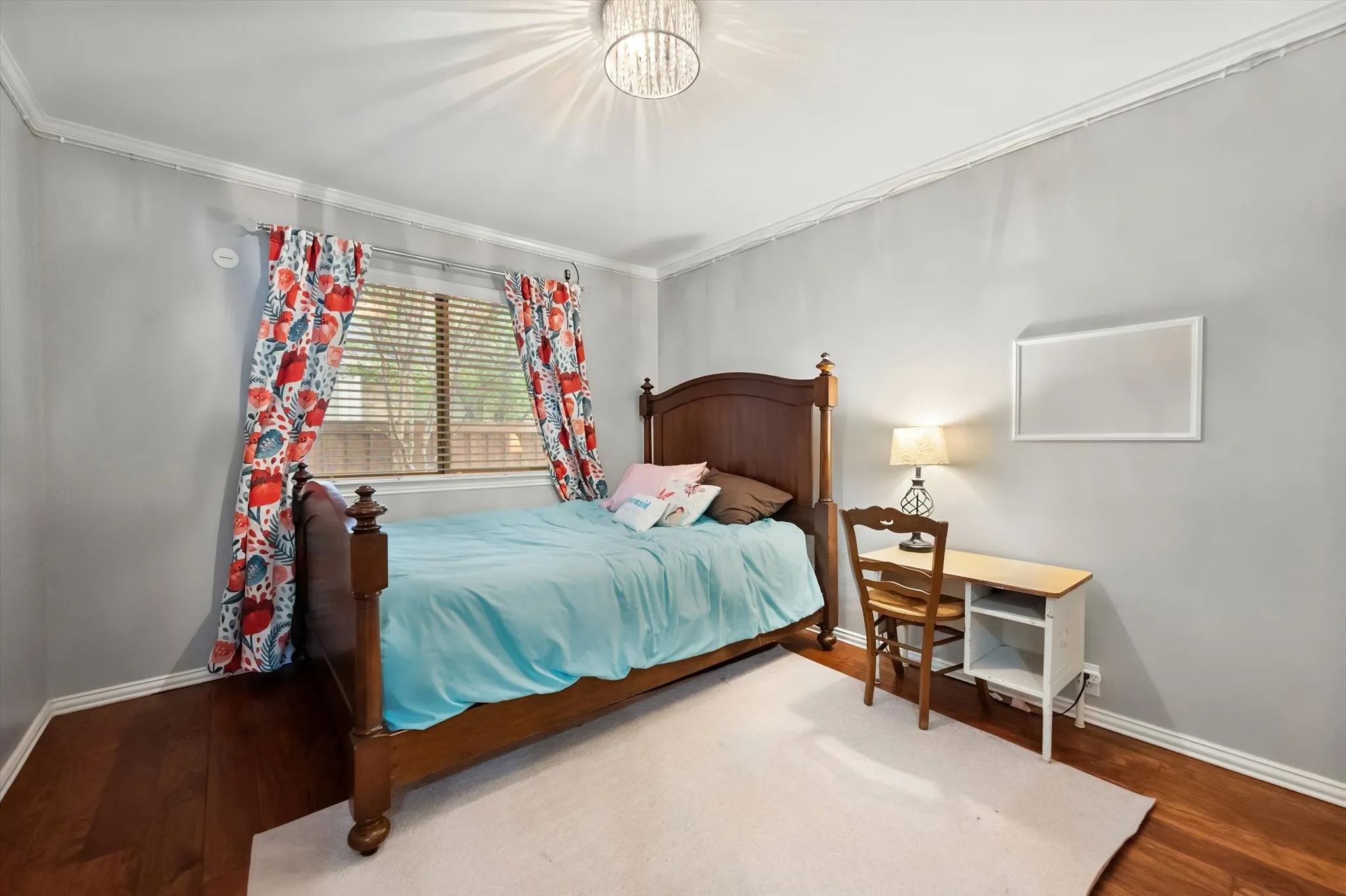 Bedroom 2 has luxury vinyl plank and decorative chandelier
