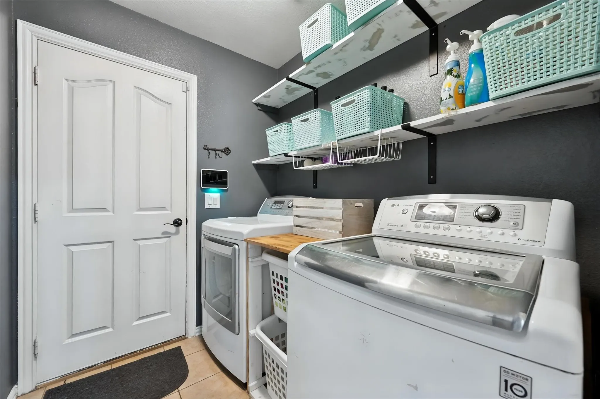 Utility room has full size W/D hookups and shelving.