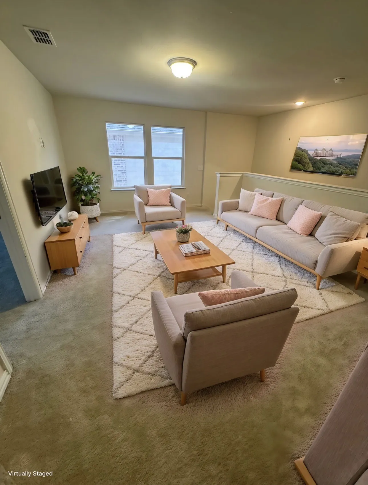 View of carpeted living area/den at top of stairs .