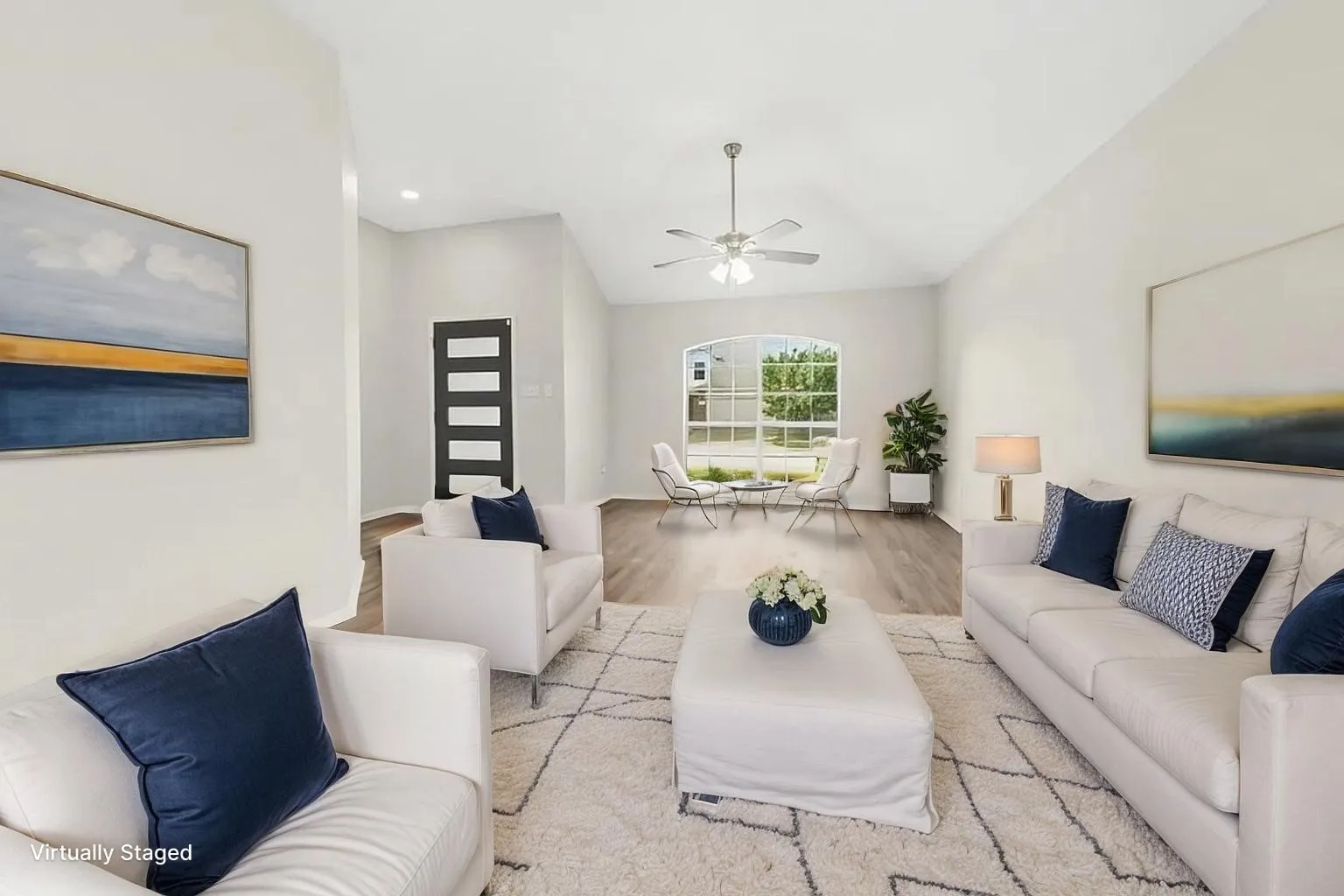 Vaulted ceilings, wood-finish flooring, an arched window, and a multi-panel glass insert entry door