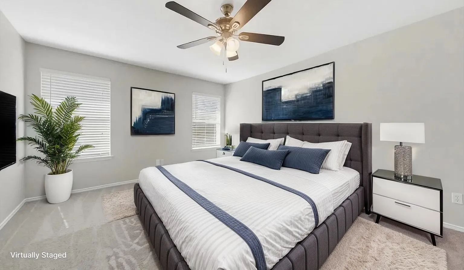Neutral-toned walls, overhead ceiling fan with integrated lighting, and multiple windows with horizontal blinds