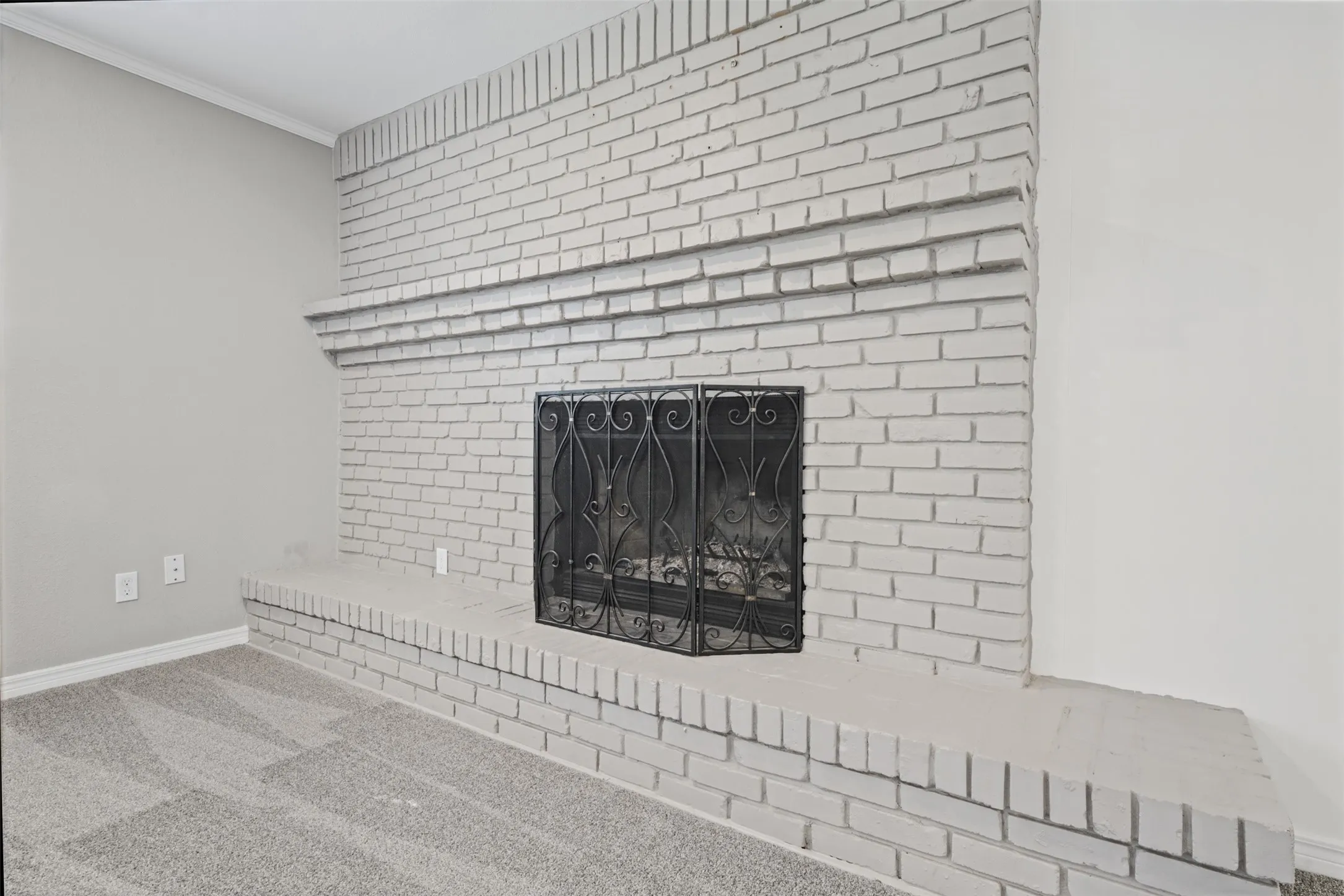 Woodburning fireplace adds charm to this family room open from the kitchen