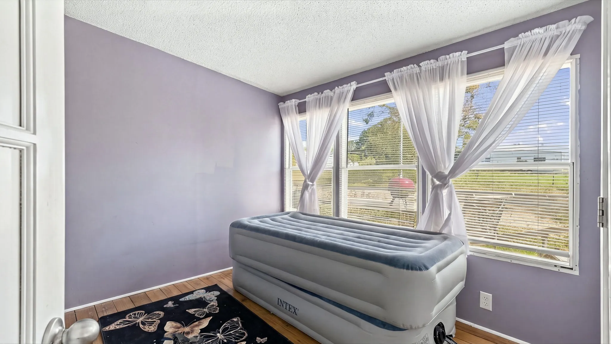 Room featuring wood-finish flooring and a wall of windows