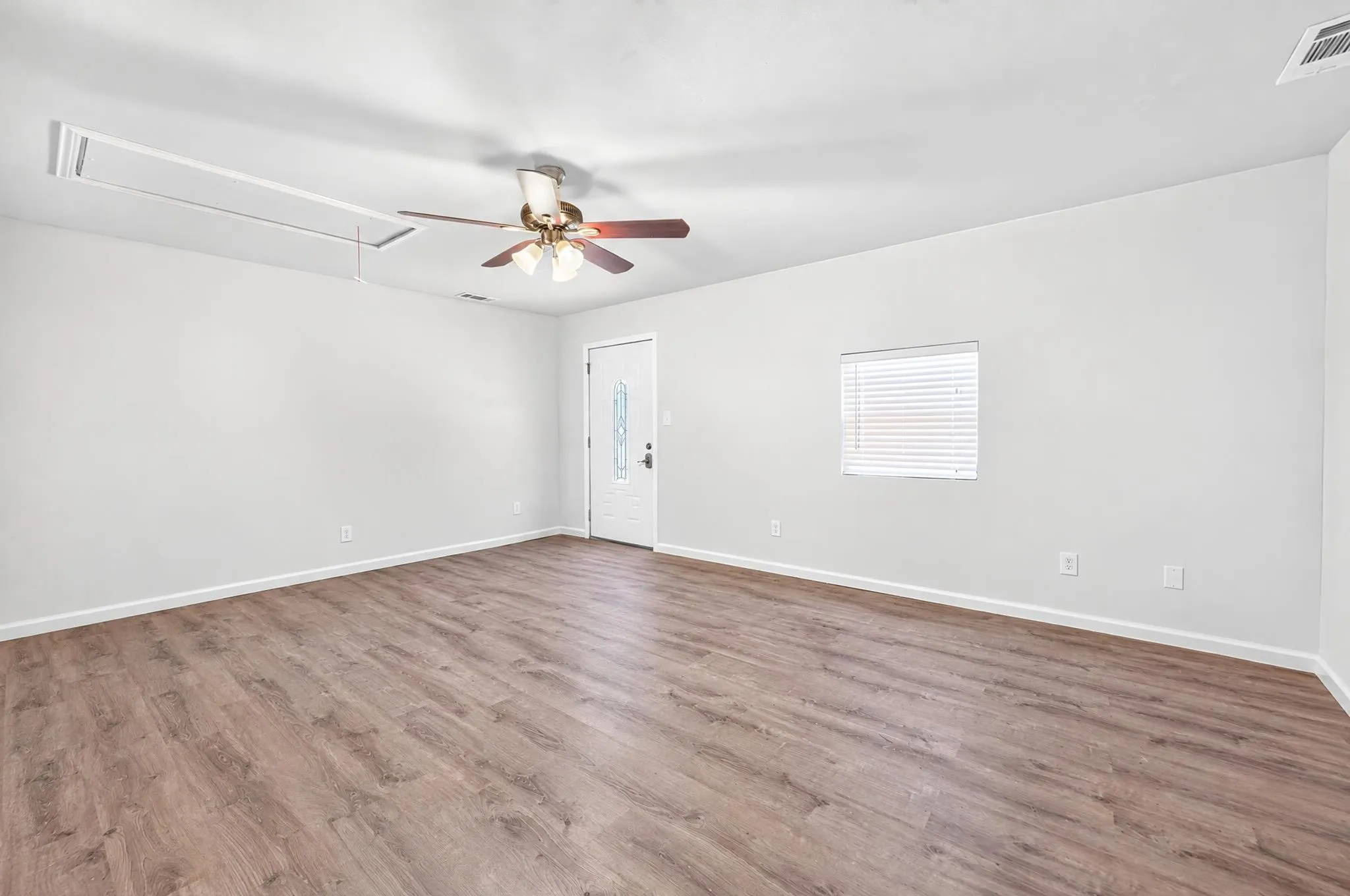 2nd Master bedroom featuring wood-finish flooring, a ceiling fan with integrated lighting, and a single-panel exterior door with a decorative glass insert
