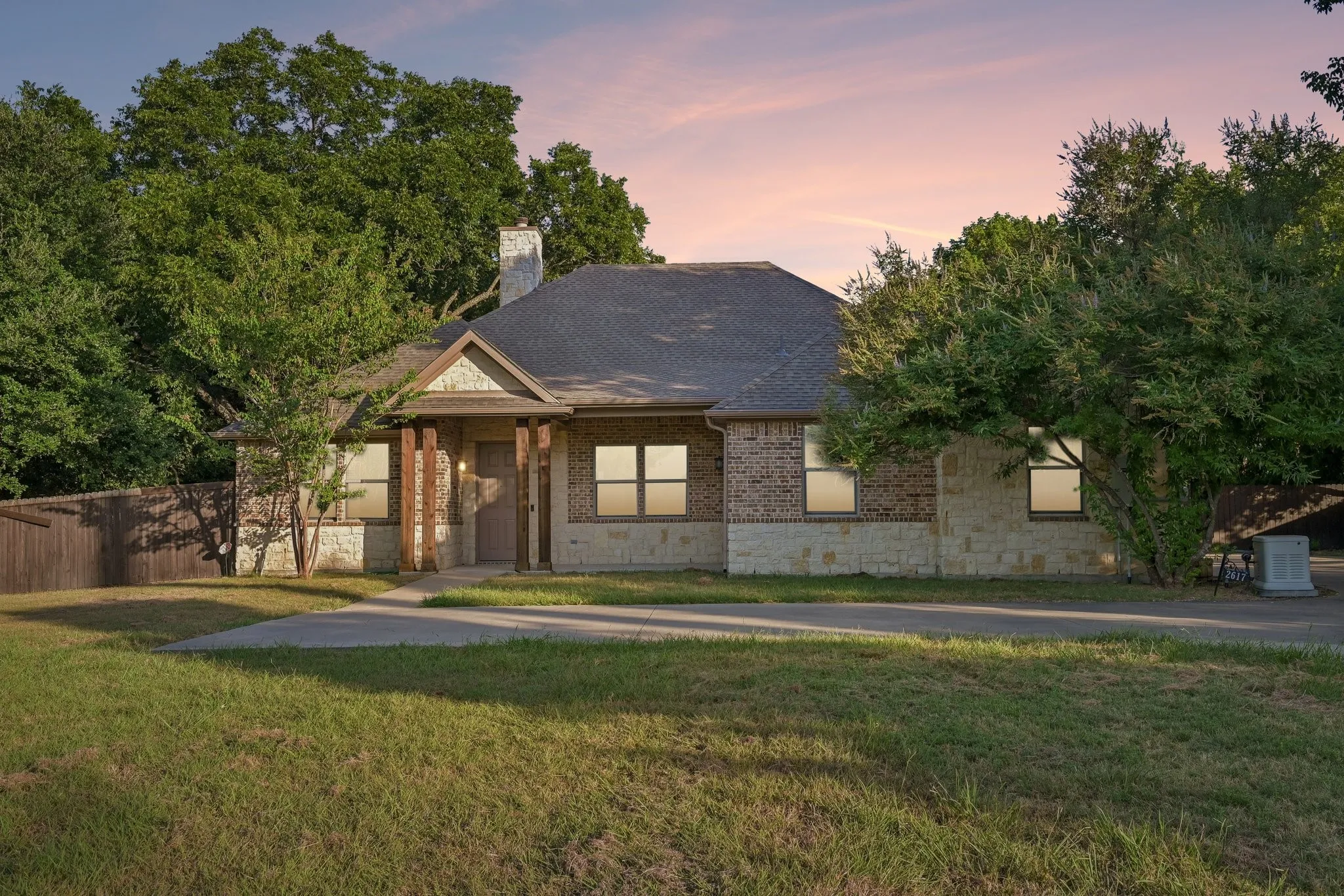 Brick and stone facade with a shingled roof