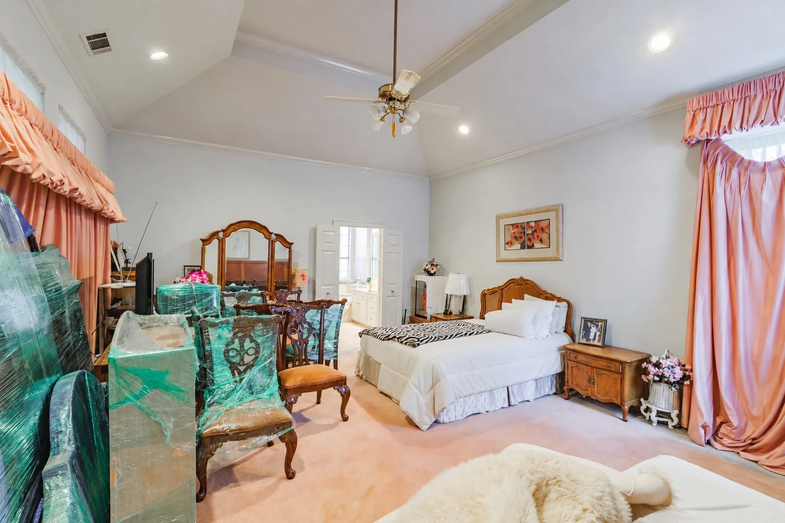 Vaulted ceiling featuring a central brass-finish ceiling fan and recessed lighting