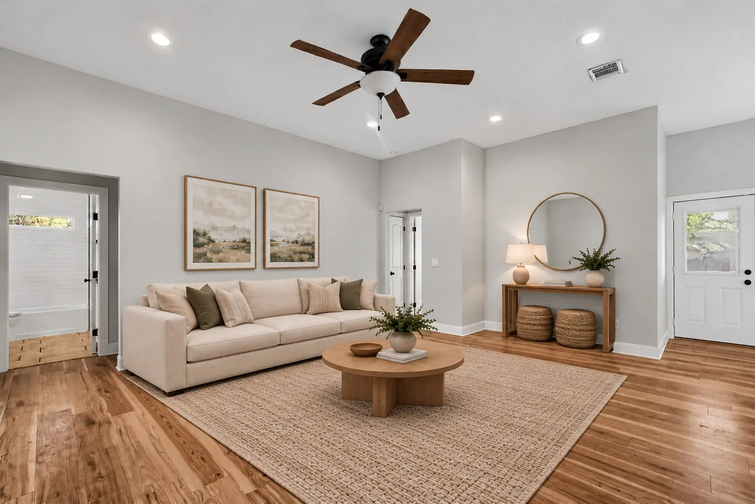 Open-concept room featuring high ceilings, wood-finish flooring, recessed lighting, and a multi-blade ceiling fan