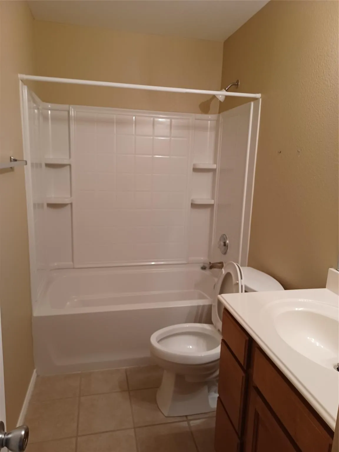 White shower-tub combination unit with integrated shelving