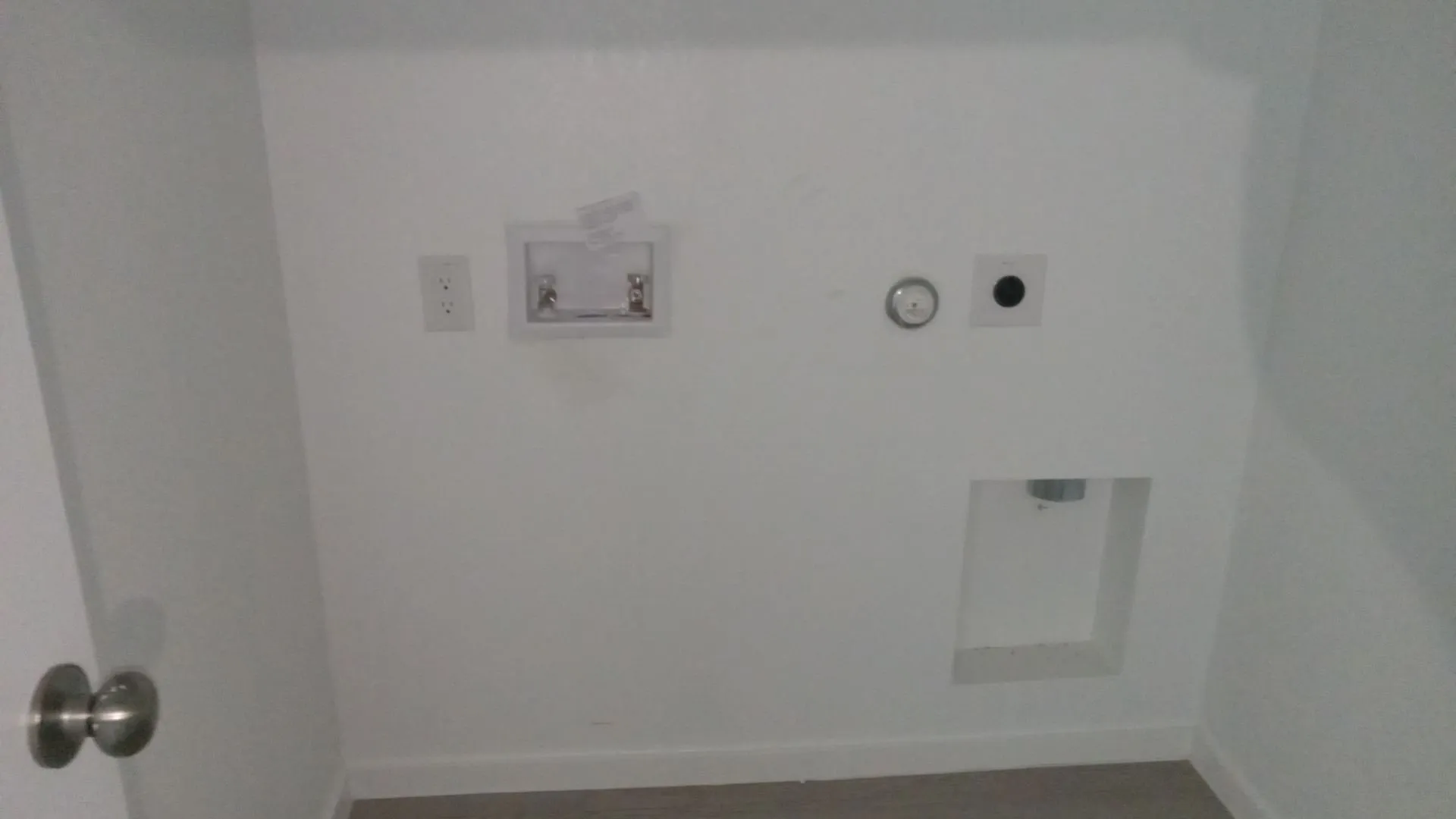 Dedicated utility area featuring washer and dryer hookups, water supply valves, and electrical outlets