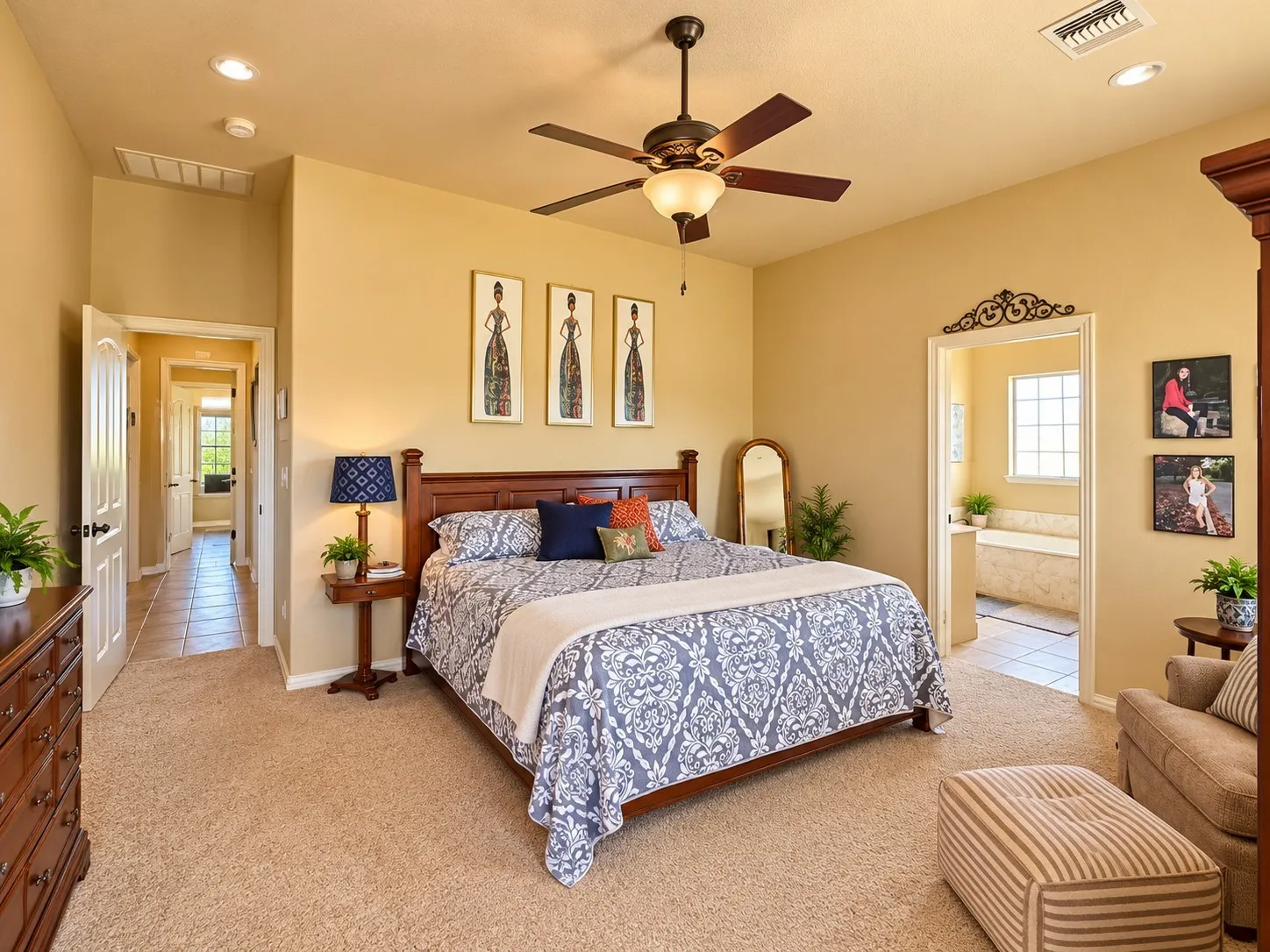 Spacious room featuring high ceilings, neutral wall tones, plush carpeting, and a central ceiling fan with an integrated light fixture
