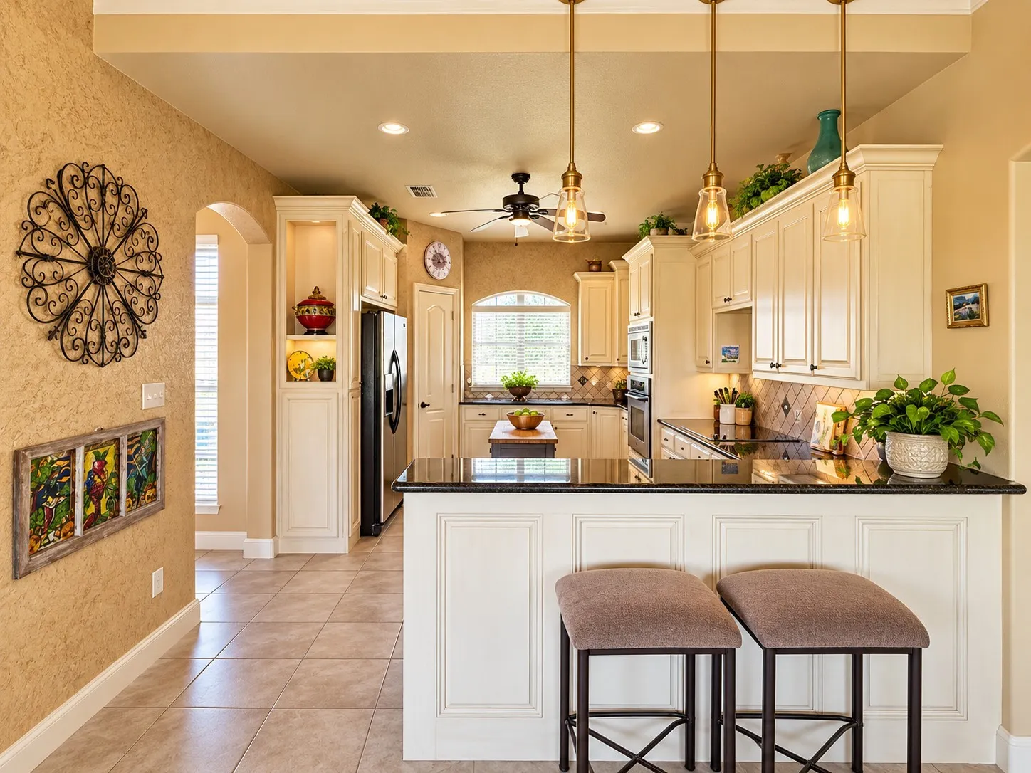 Kitchen featuring white cabinetry, dark stone countertops, tile flooring, recessed lighting, and three glass pendant lights