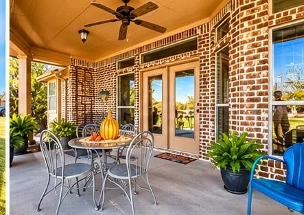 Covered patio featuring brick exterior, concrete flooring, transom windows, and a ceiling-mounted fan