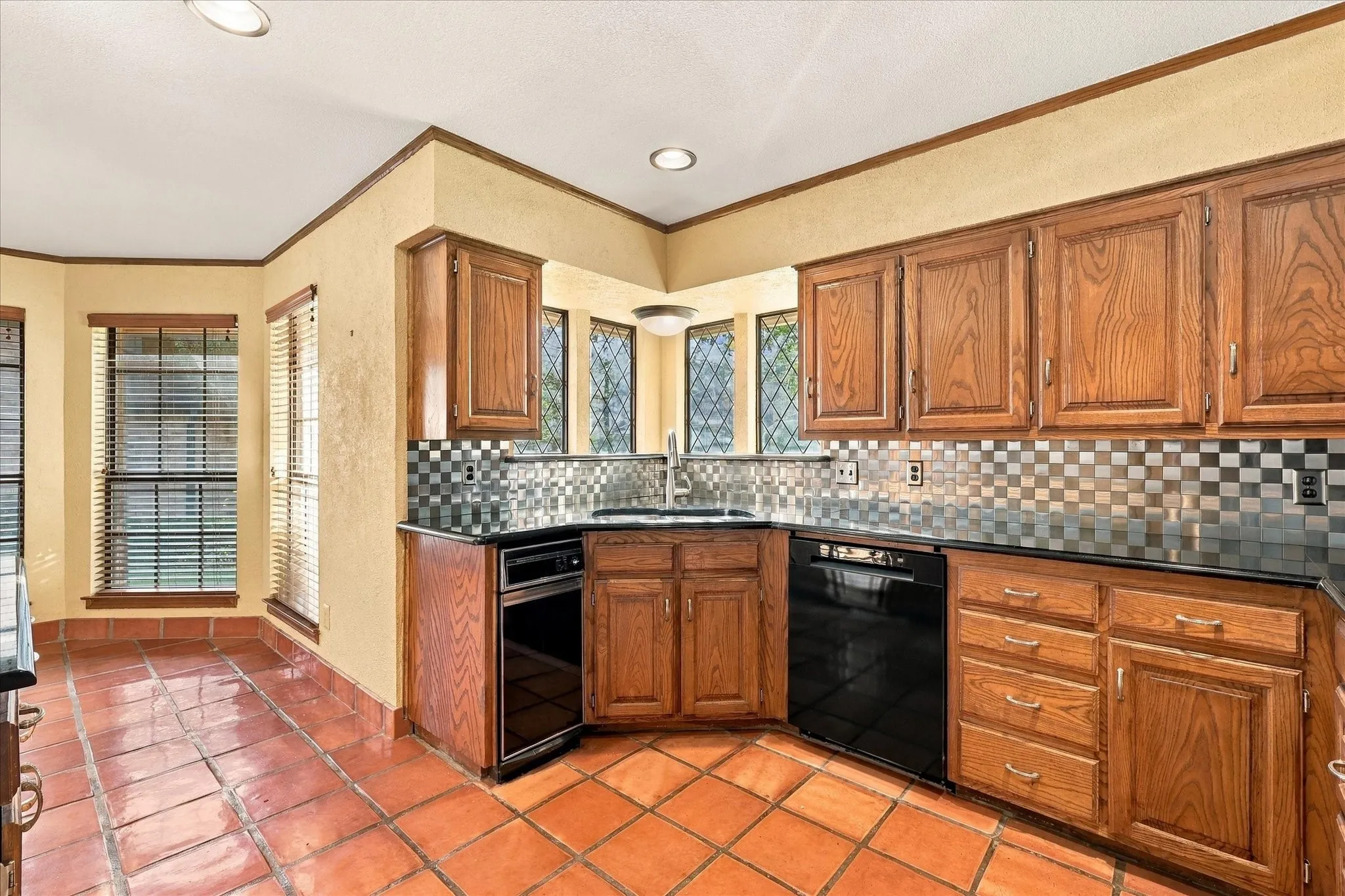 Kitchen with wood cabinets and an adjoining breakfast area.