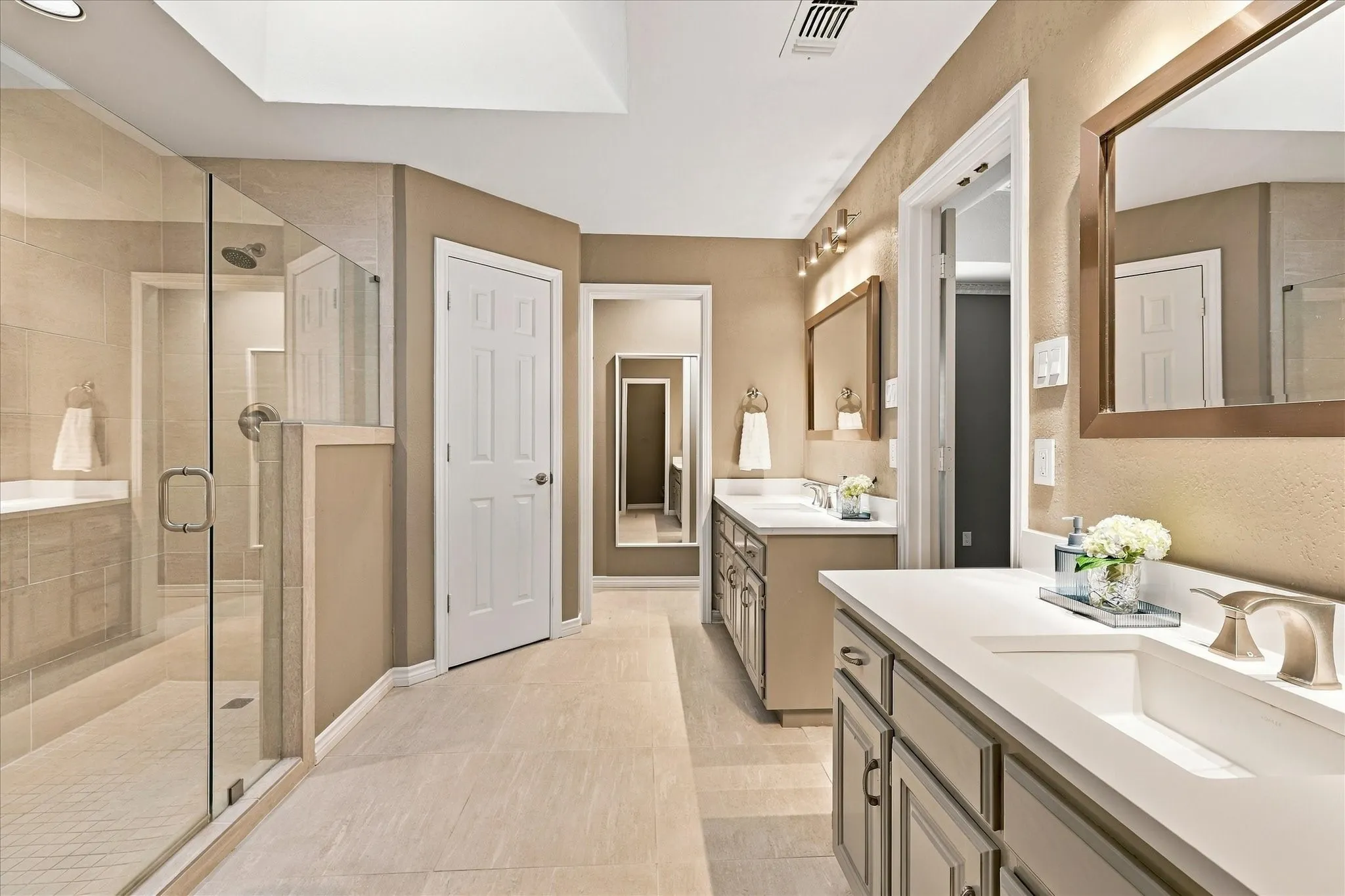  Primary bathroom showing the vanity and shower layout.