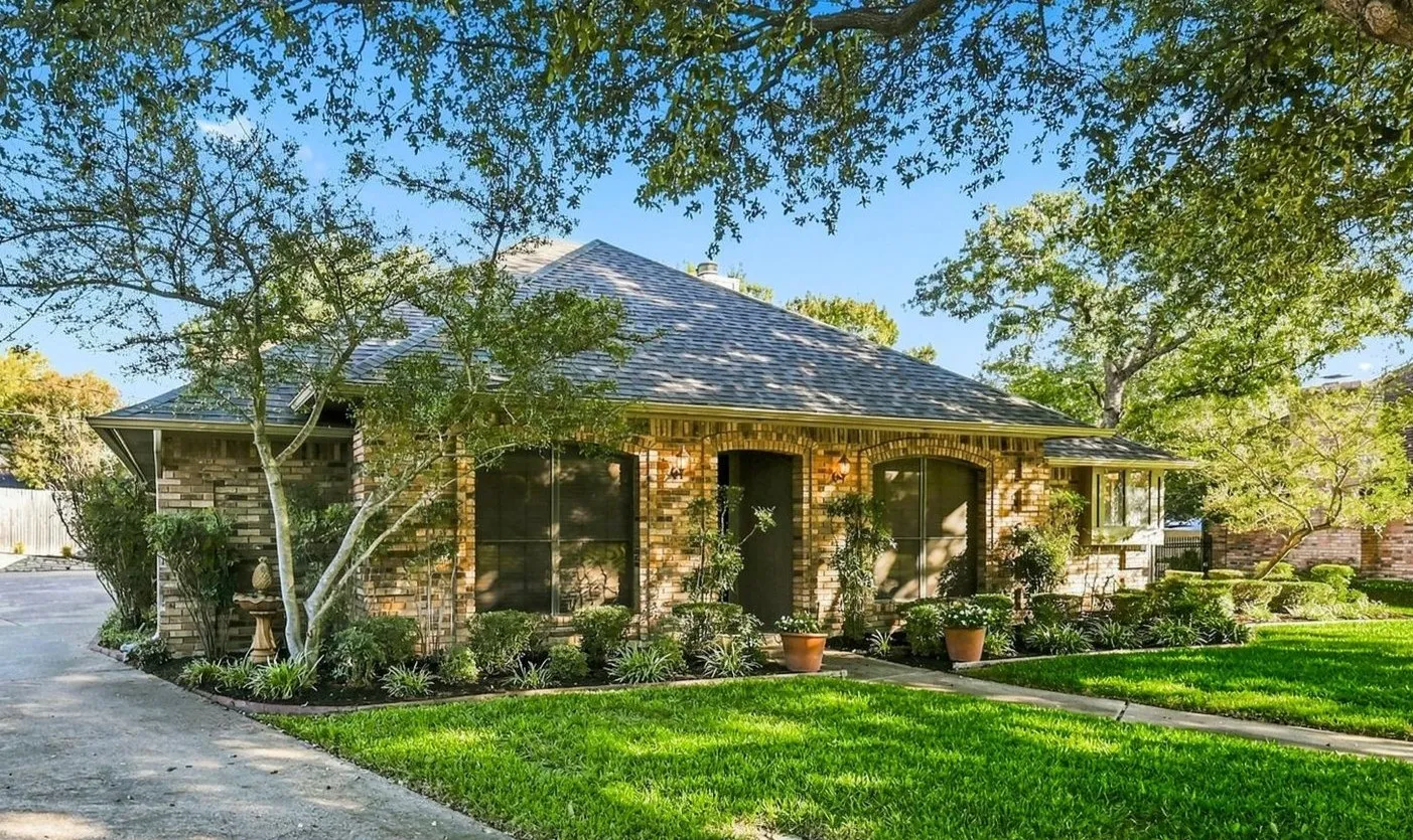 Mature trees frame the front entrance.