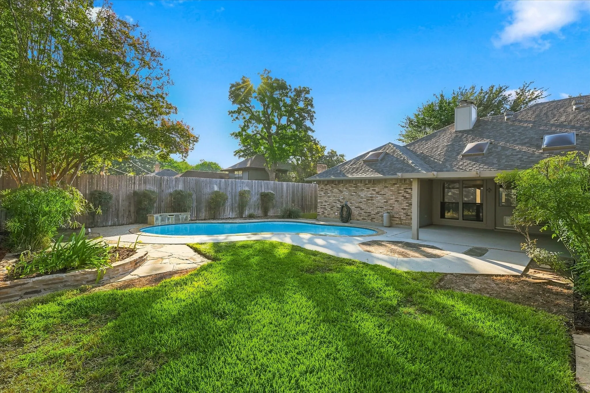  Backyard with lawn, mature trees and pool.