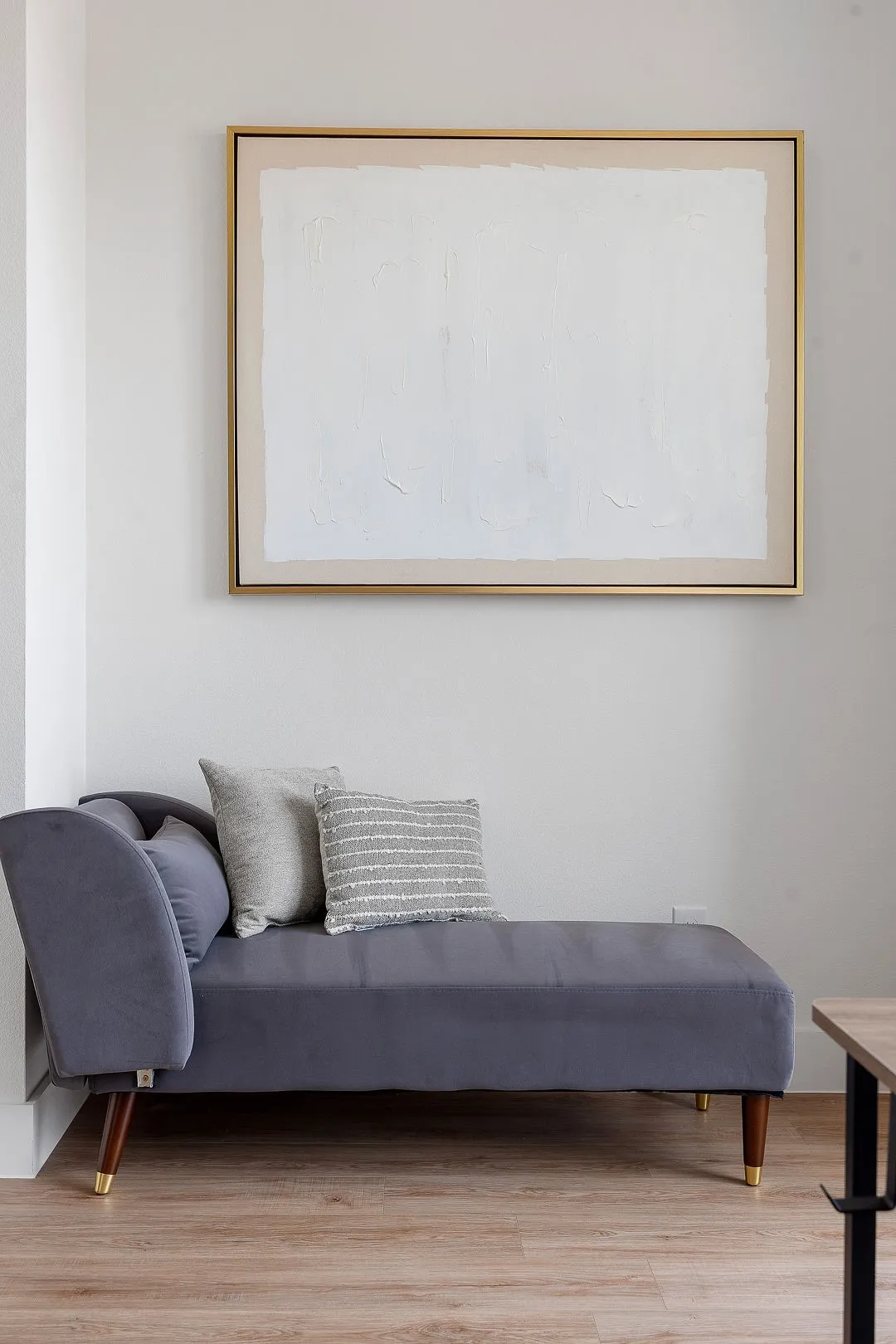 Neutral wall finish and light-tone wood-finish flooring