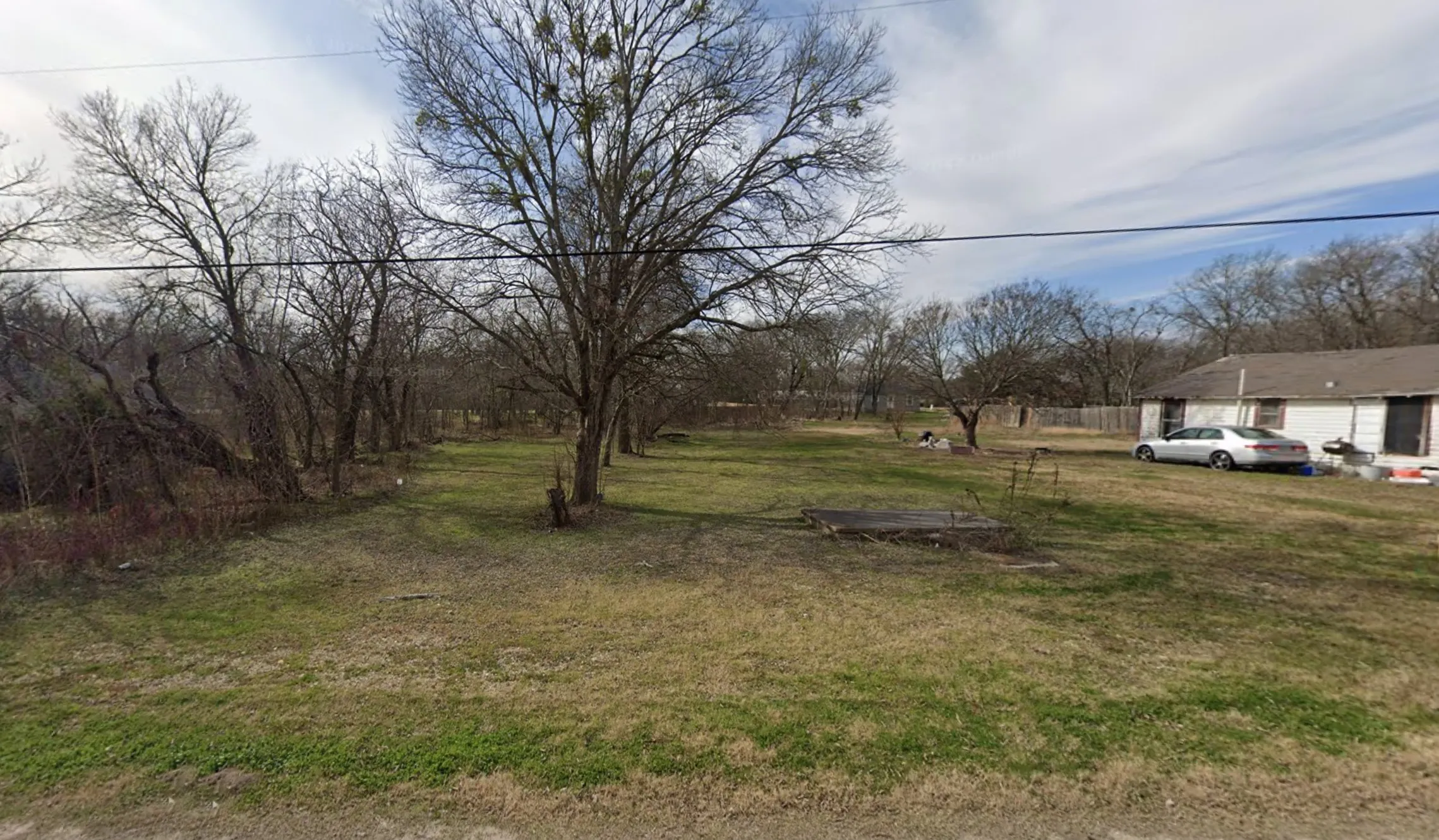 Expansive lot featuring mature trees and established grass