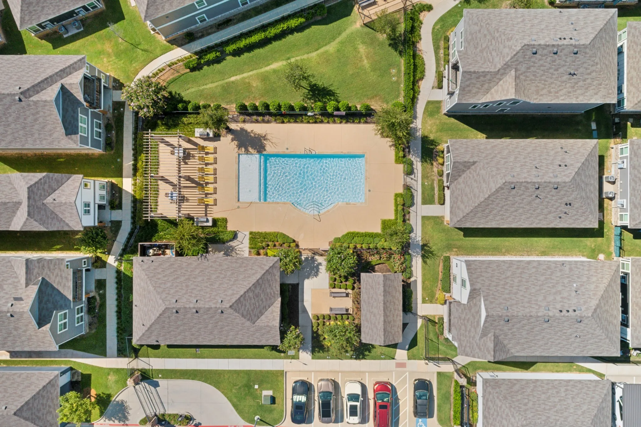 Community amenities including a swimming pool, pergola-covered deck, landscaped grounds, and paved walkways