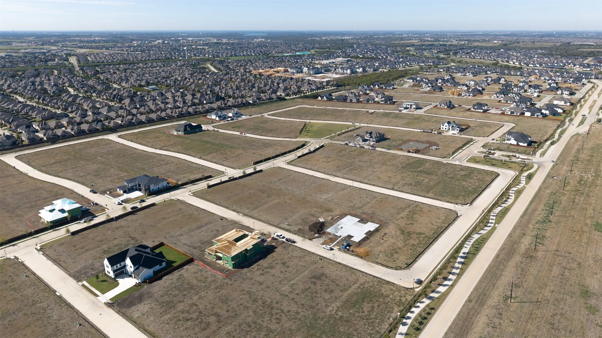 Expansive residential building lots featuring established concrete infrastructure, paved curbing, and utility access