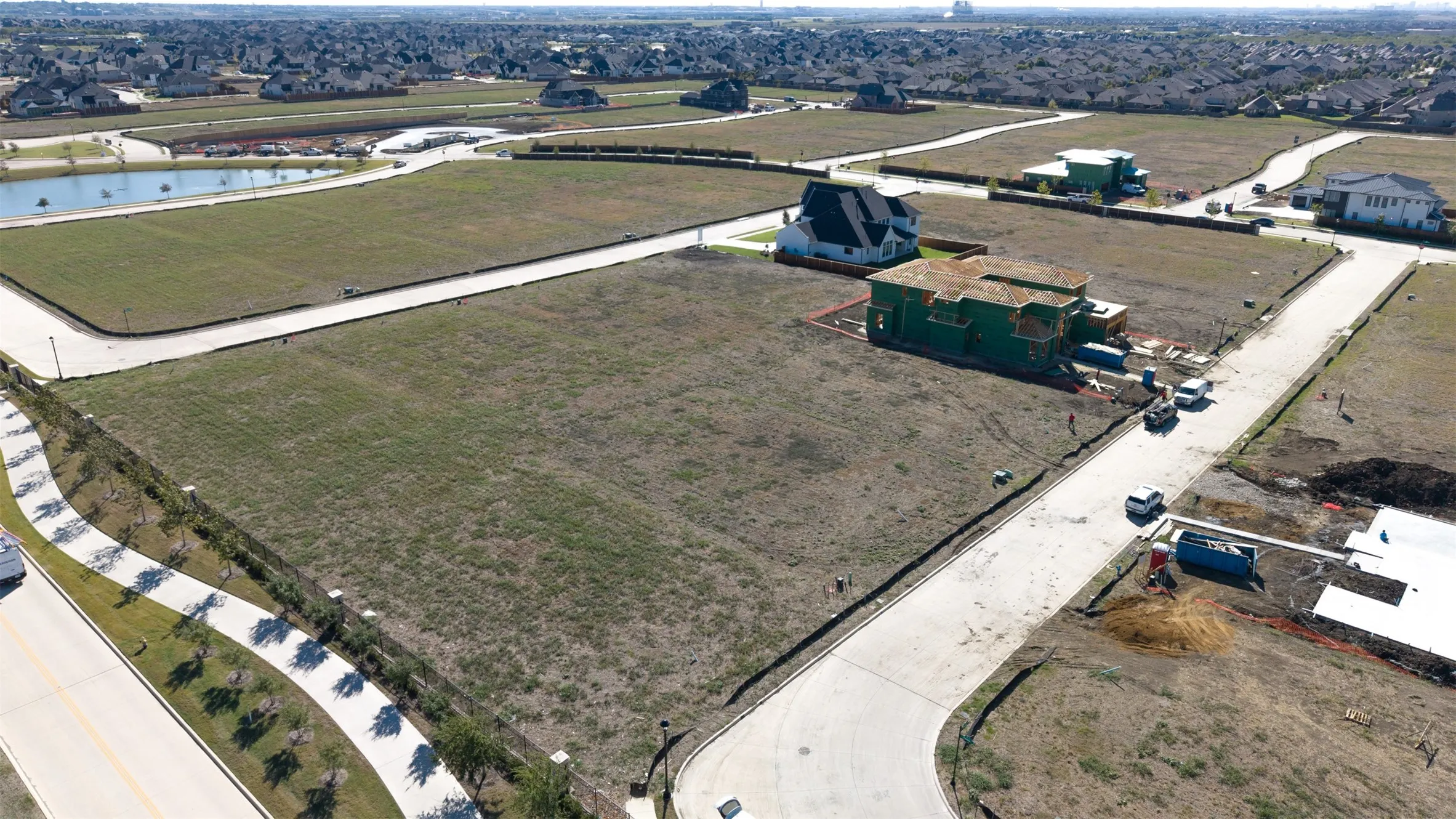 Expansive corner lot featuring concrete curb-and-gutter infrastructure, underground utilities, and street access