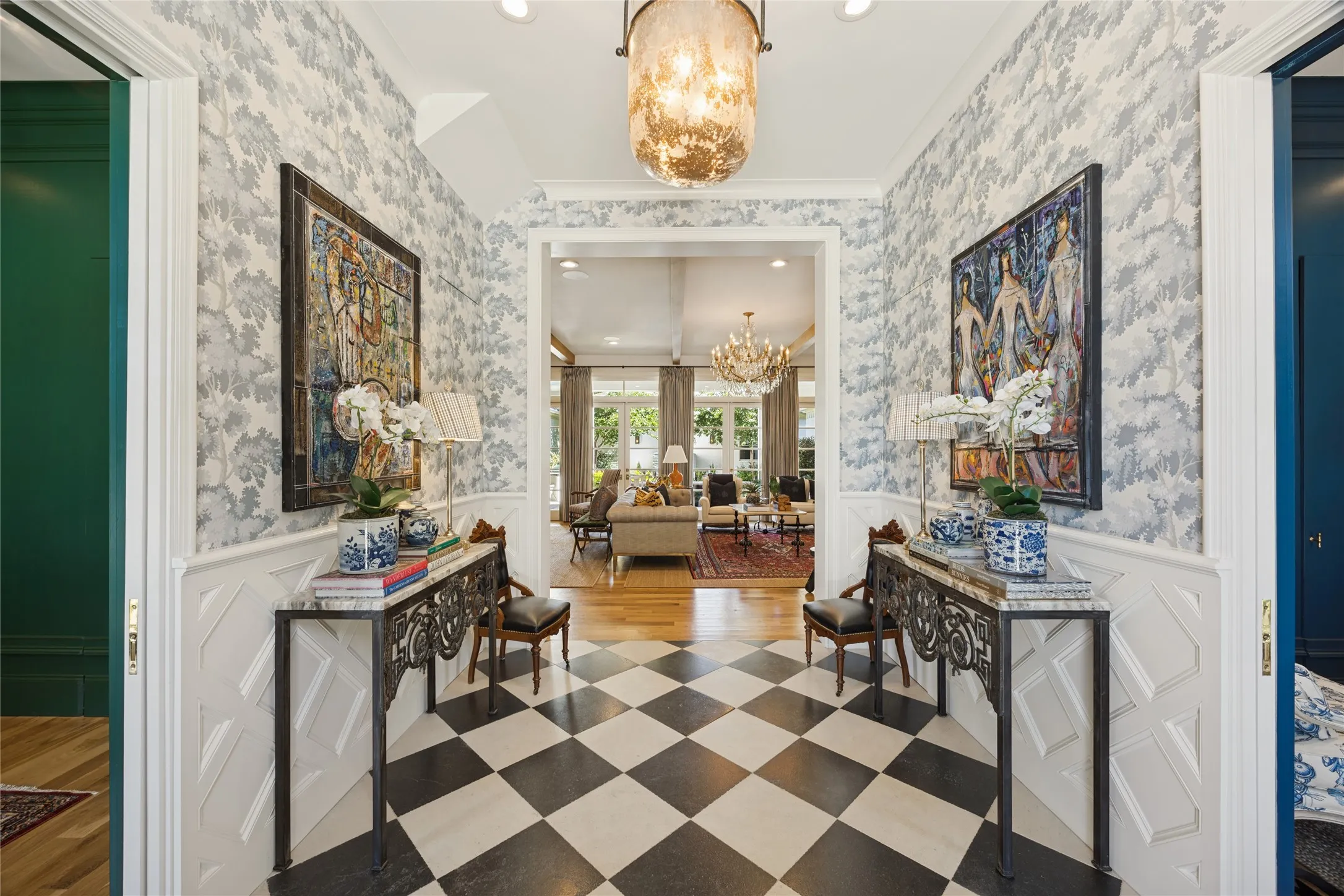 Foyer featuring black and white checkerboard flooring, wainscoting, decorative wallpaper, and a central pendant light​​‌​​​​‌​​‌‌​‌‌​​​‌‌​‌​‌​‌​​​‌​​ fixture