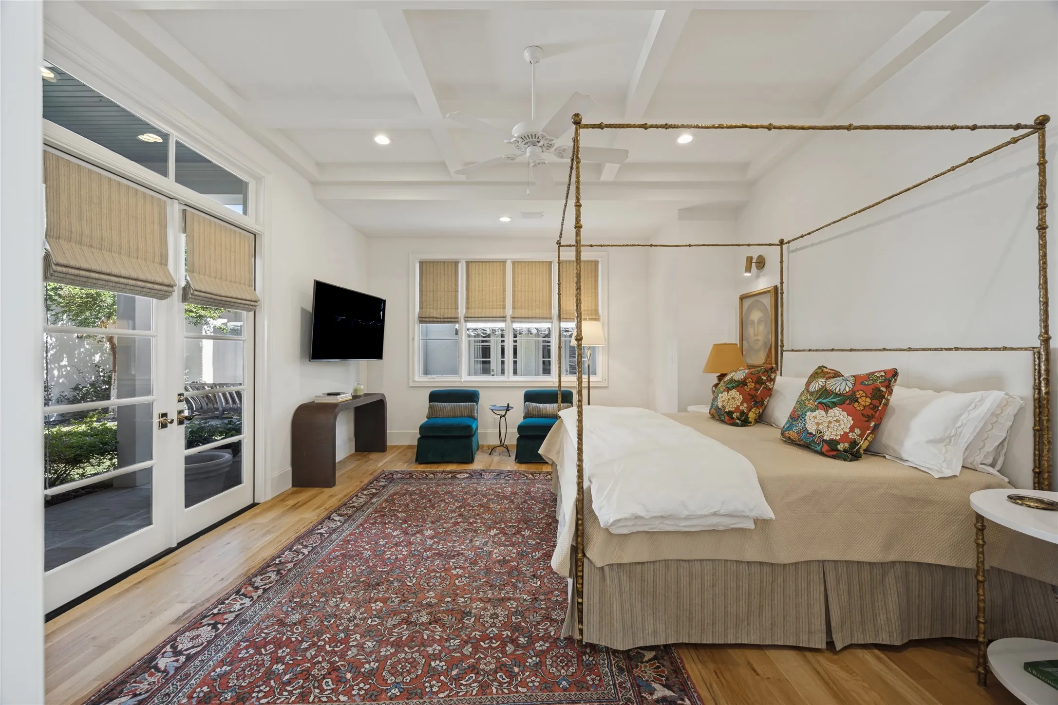 Coffered ceiling with recessed lighting, wood-finish flooring, and glass-paneled exterior door featuring transom window